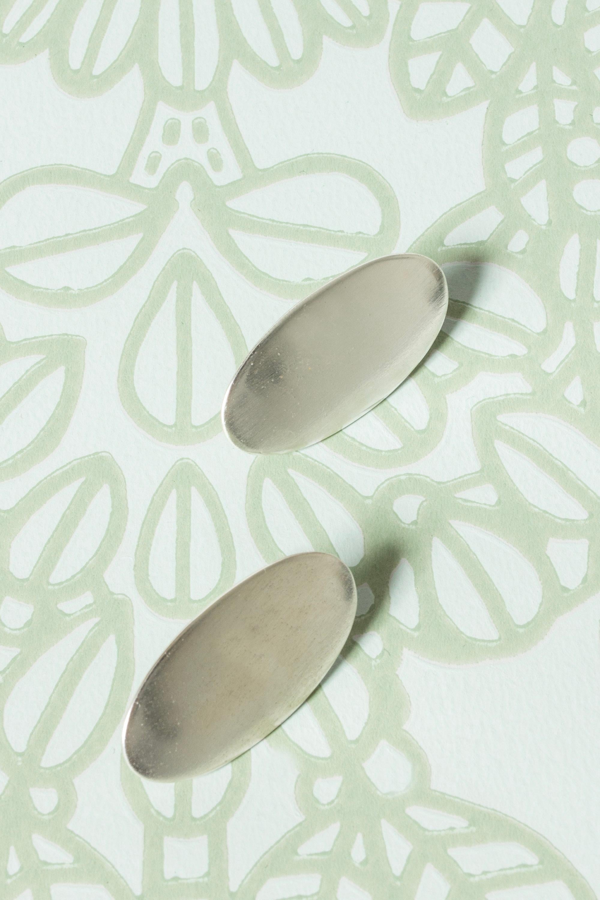 Pair of cool and elegant silver earrings from Niels Erik From, in an almond shape. Brushed surface.