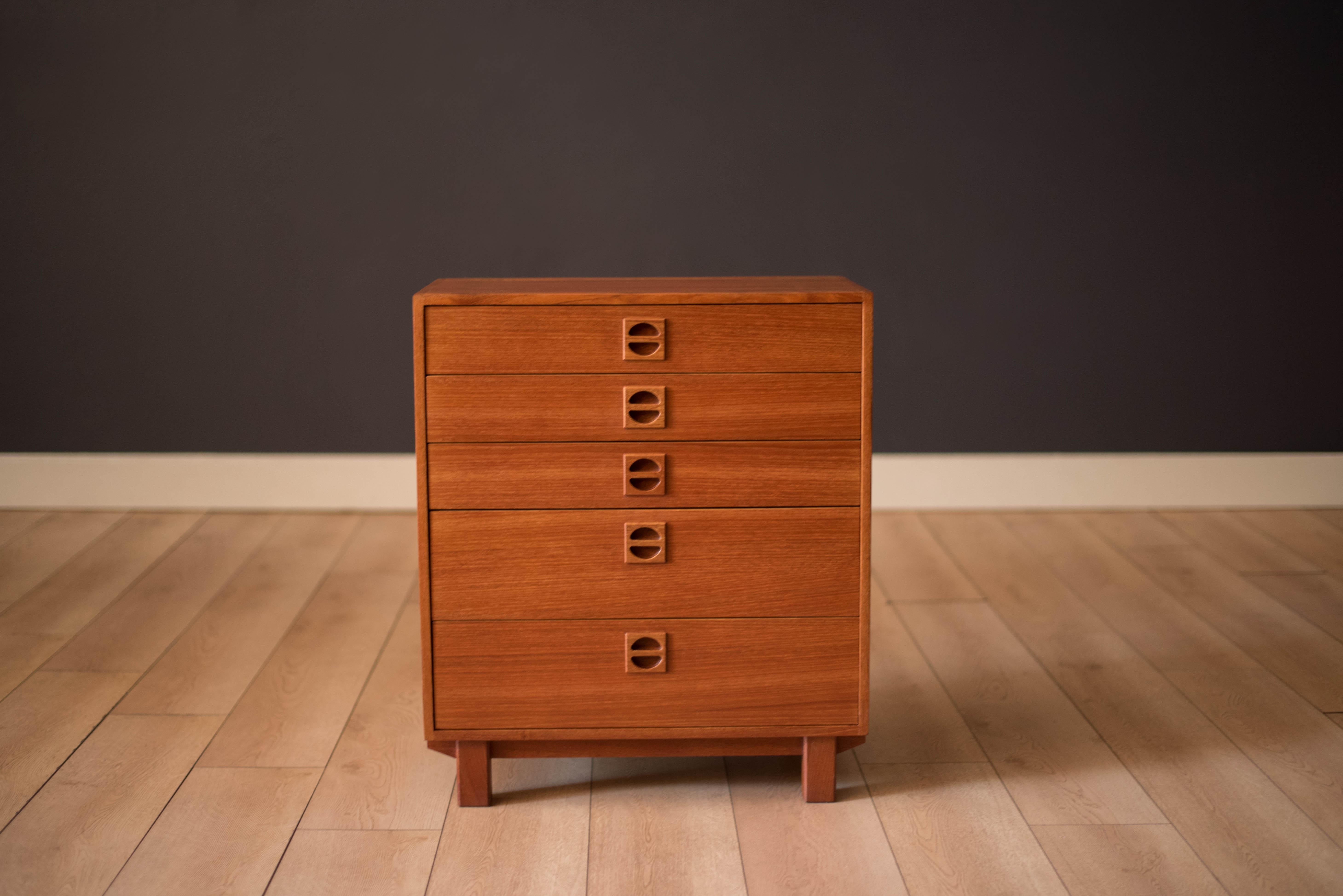 Mid-Century Modern dresser chest in solid teak circa 1970's made in Sweden. This case piece is built with exposed finger joinery and includes five drawers with dovetail construction. The perfect space saving storage solution for a bedroom or