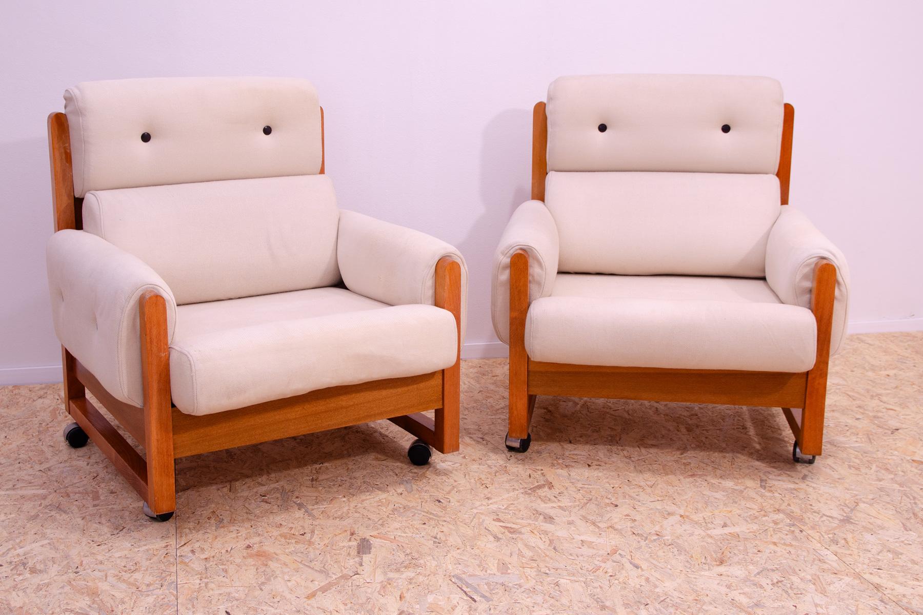 This lounge Scandinavian style armchairs were made in the 1970´s. It is upholstered with fabric. The structure is made of beech wood and the furniture stands on metal wheels. All in very good Vintage condition, shows slight signs of age and use.