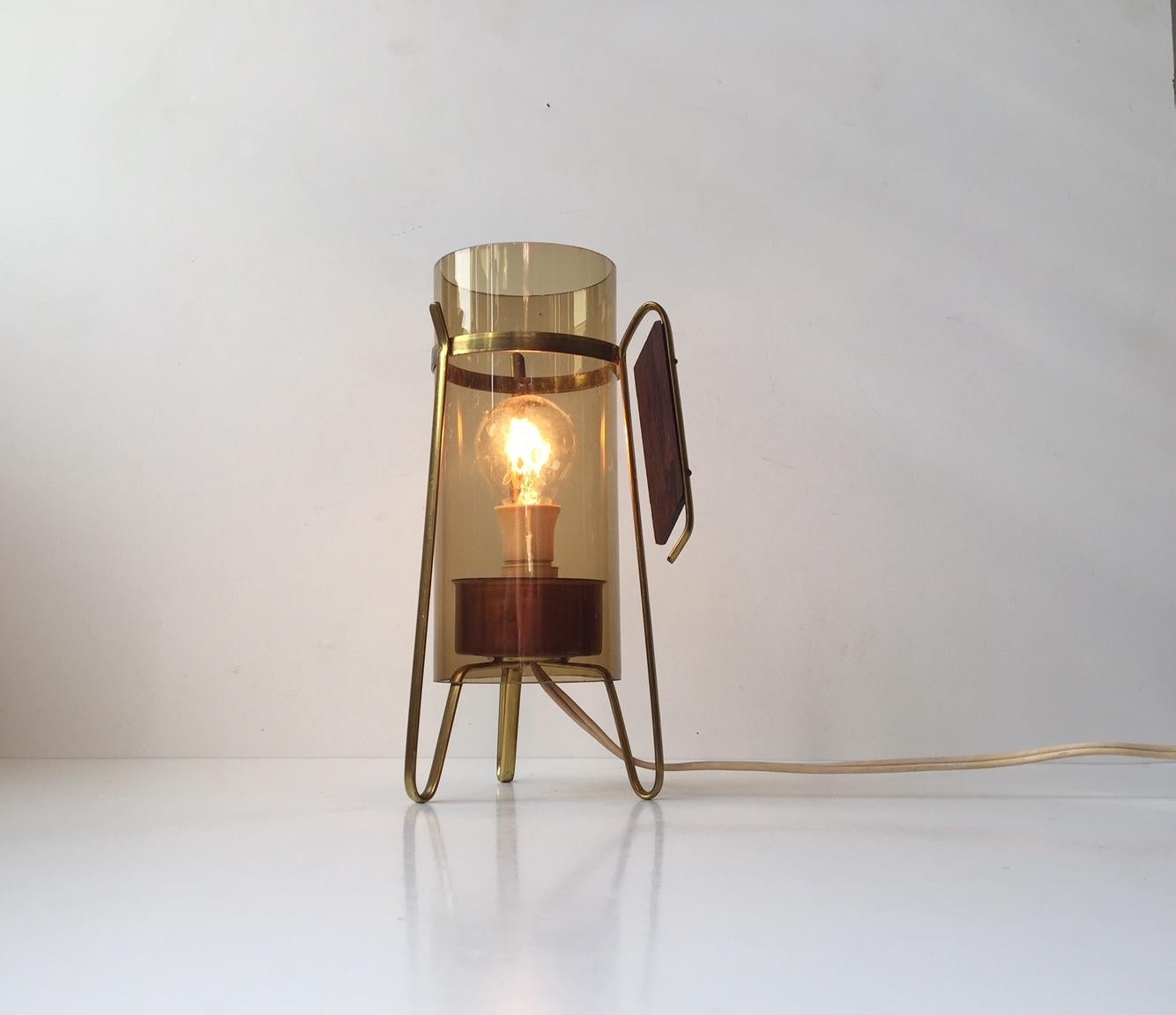 This small, decorative table lamp is made from brass, copper, and smoked glass. The handle is solid rosewood. Anonymous Scandinavian maker, 1960s.