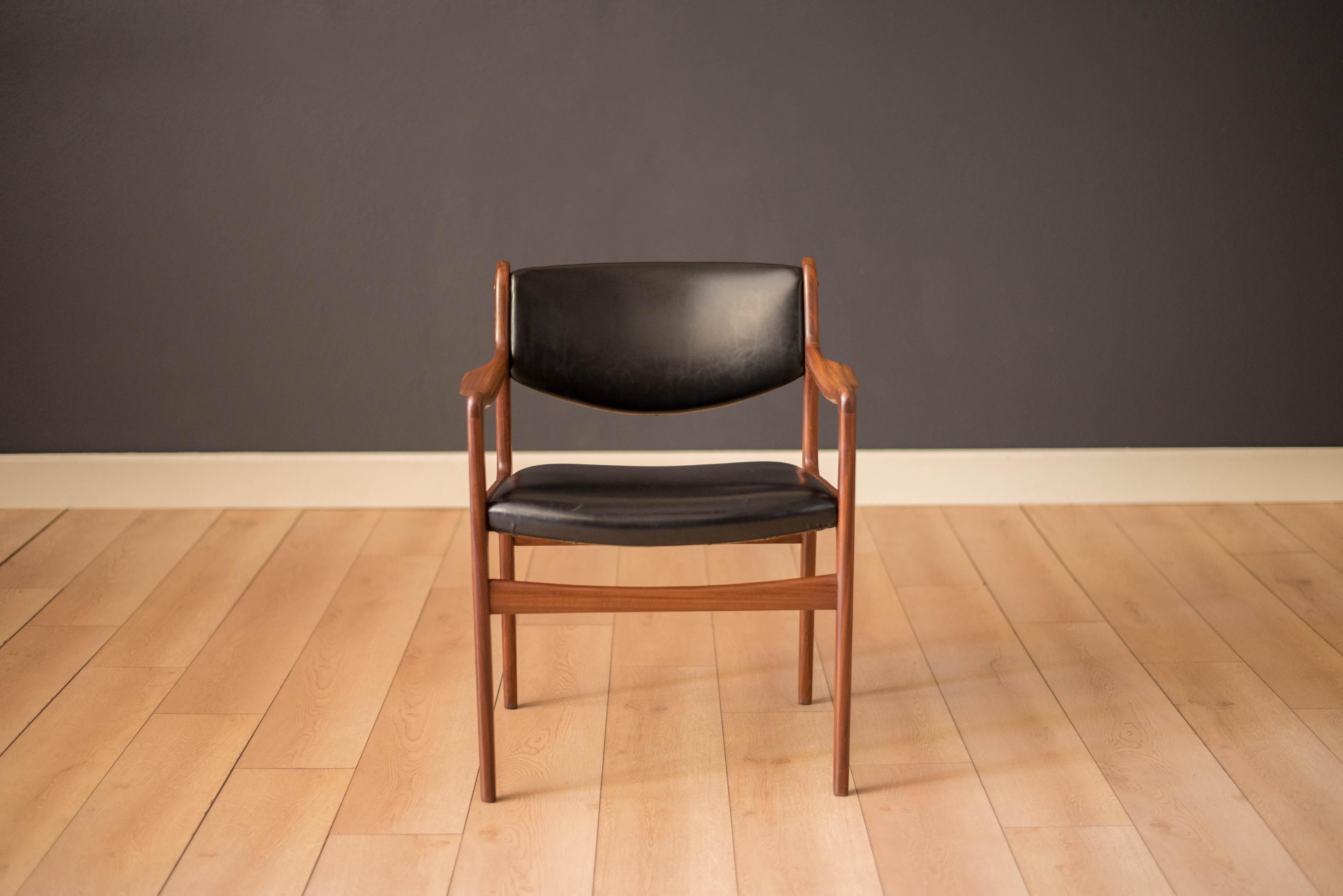 Mid-Century Modern armchair manufactured by Westnofa of Norway. This piece features a sculpted teak afromosia frame and the original black vinyl backrest and seat. Perfect to use as an office chair or dining chair.