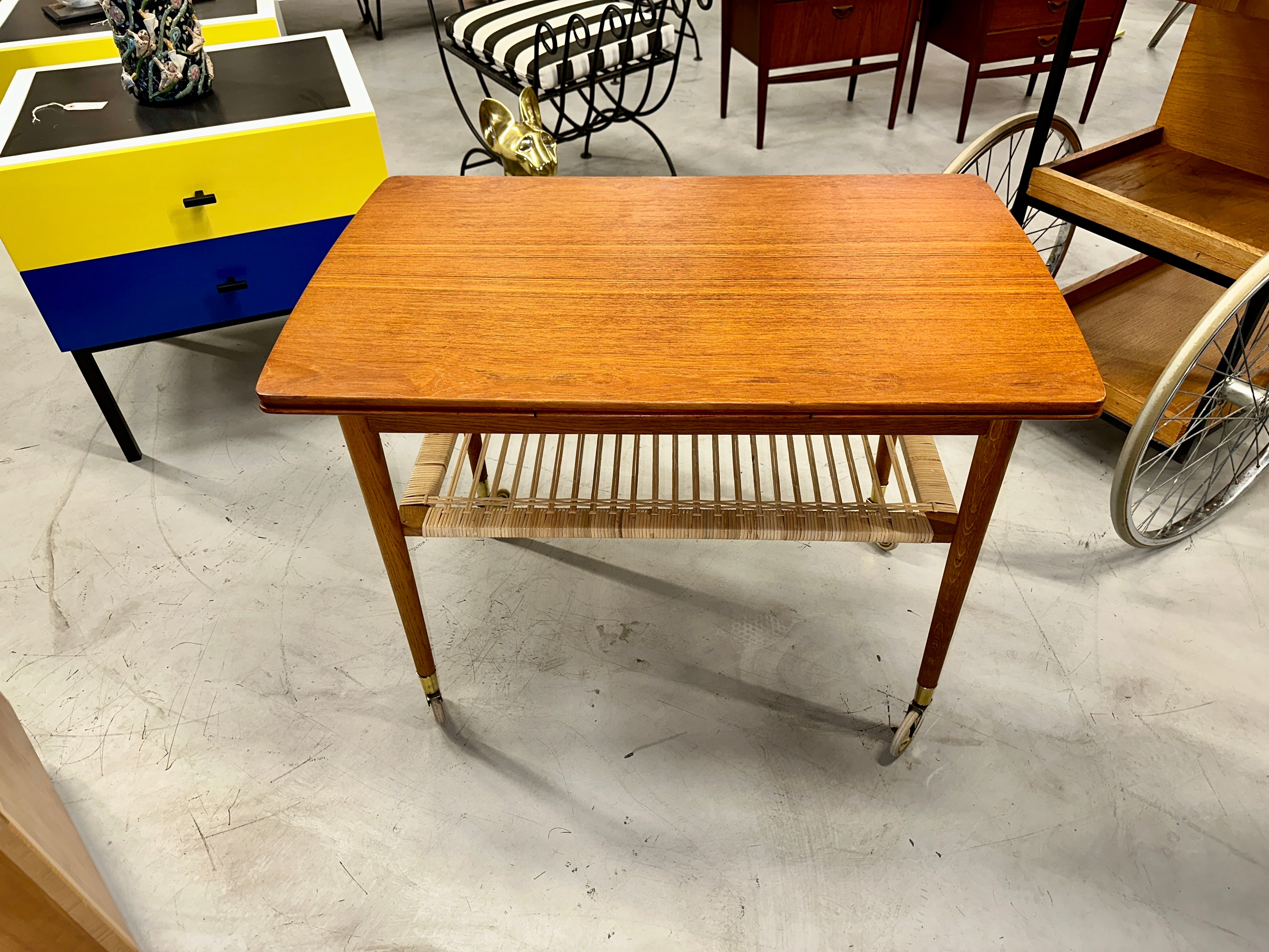 Nice vintage Teak Scandinavian bar cart or trolley on wheel. It features wings that pull out and set in place. In good age appropriate condition although there is a dark mark on one end that is pictured.