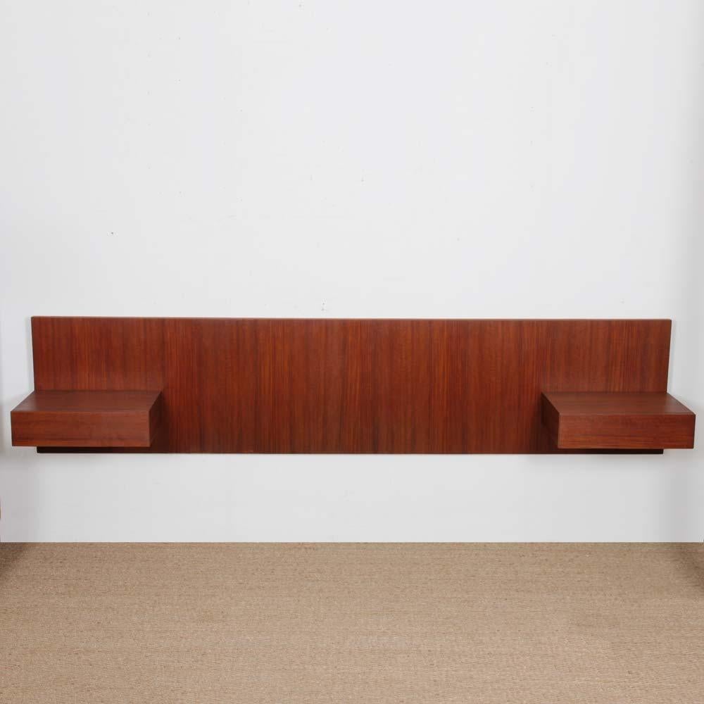 This vintage Scandinavian teak headboard dates from the 1960s. It includes 2 integrated nightstands. The frame is made for a bed measuring 140 cm. This piece of furniture has been restored.