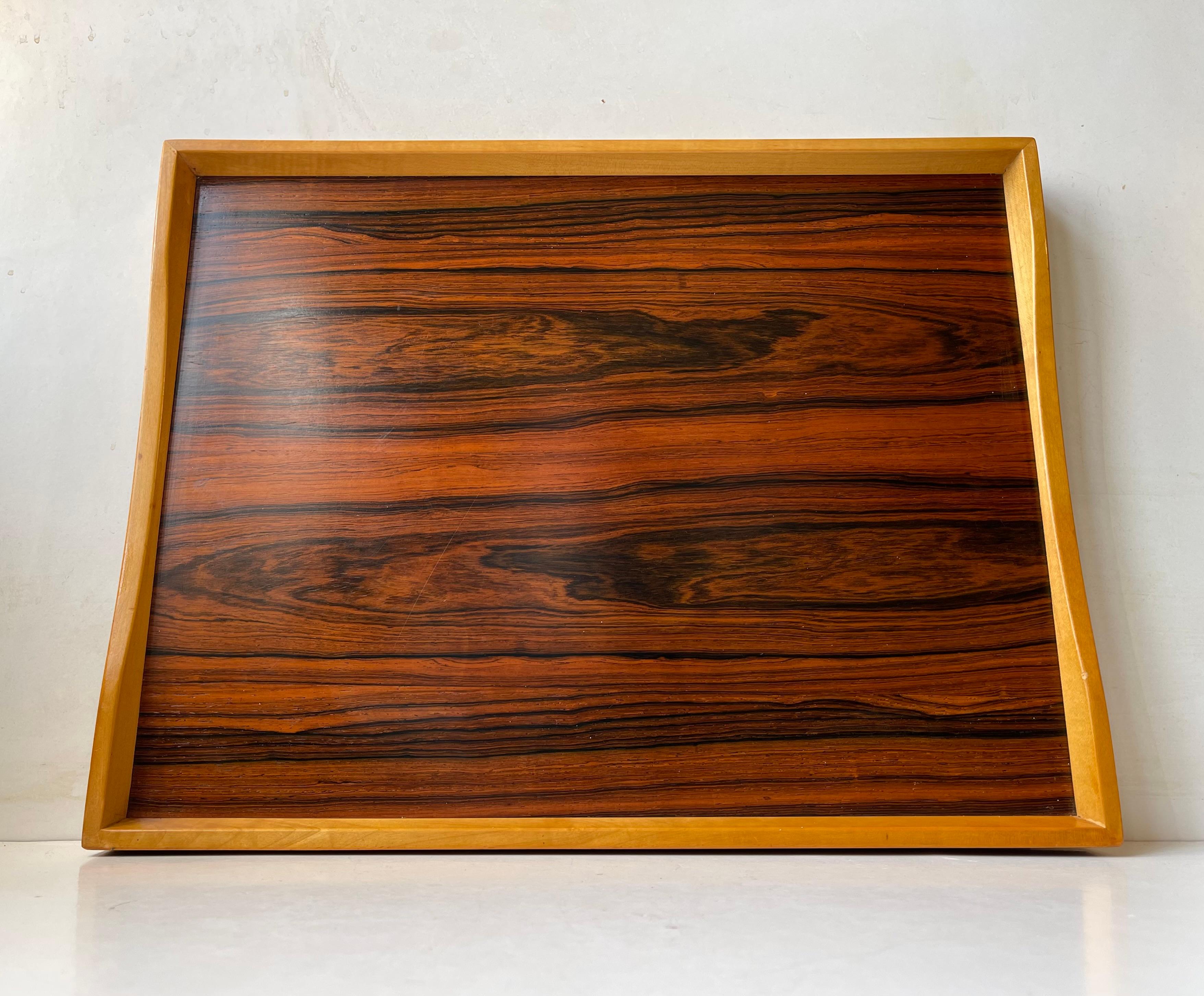 2 sided turning tray made from rosewood veneer and beach and assembled without the use of metal. Made in Scandinavia during the 1960s or 70s in a style reminiscent of Finn Juhl's turning tray in formica. Large practical size.   

Measurements: