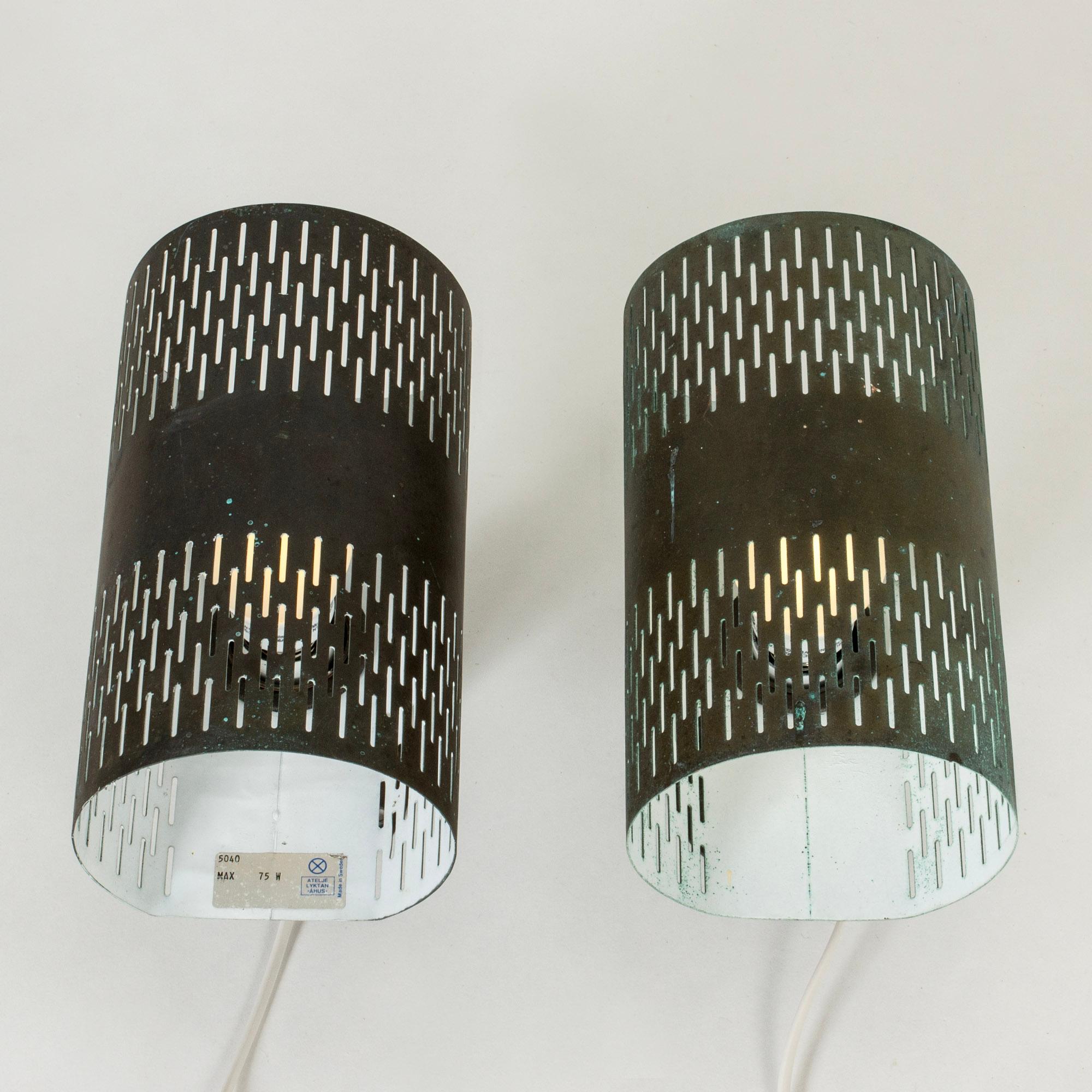 Very cool pair of wall lights by Hans Bergström, made from copper. Cylinder forms with a cutout graphic pattern.

Rewired but need to be installed by an electrician if mounted outdoors.

Hans Bergström was the owner and creative director of the