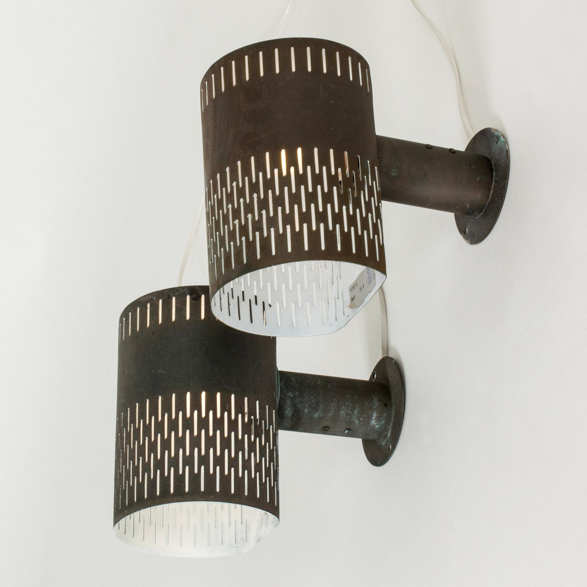 Very cool pair of wall lights by Hans Bergström, made from copper. Cylinder forms with a cutout graphic pattern.

Rewired but need to be installed by an electrician if mounted outdoors.

Hans Bergström was the owner and creative director of the