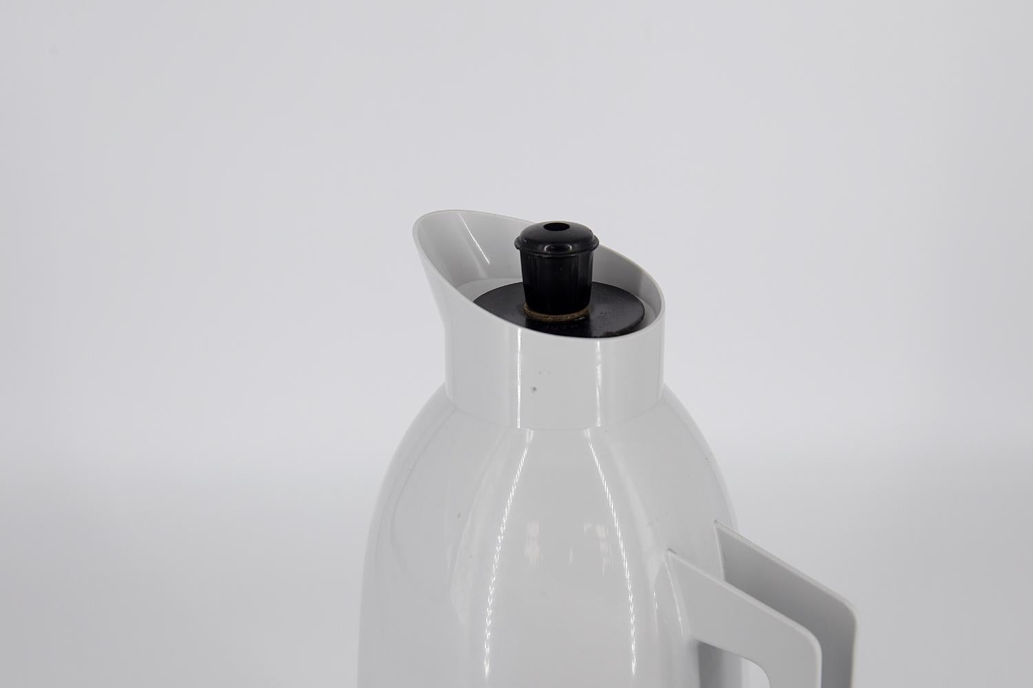 This thermal jug was designed by G. Rosendahl for the Swedish Falkenberg manufacture during the 1960s. Thermos flask made of white plastic with a black base. The convenient pouring inlet is designed so that nothing spills out while in use. The cork