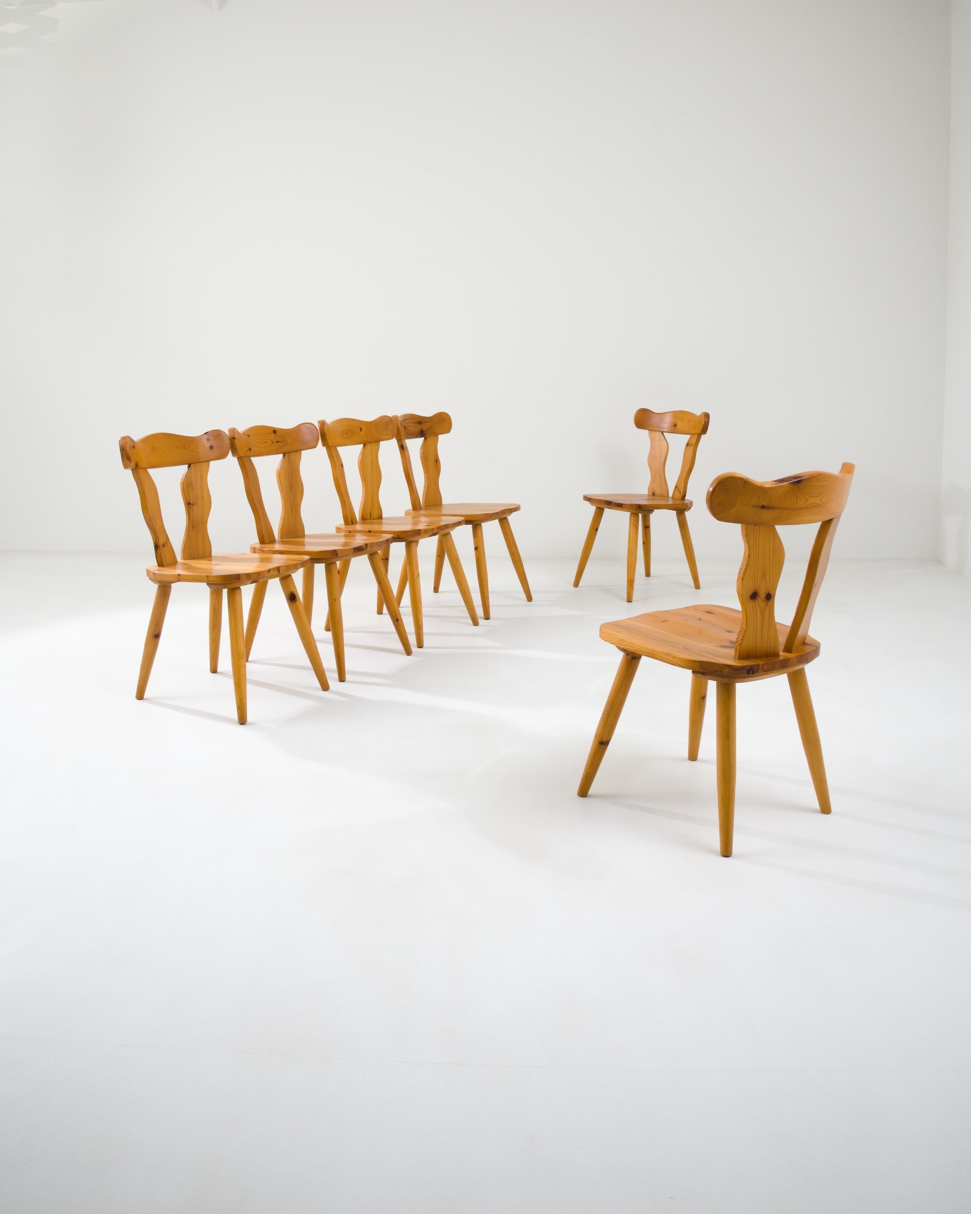 A set of wooden dining chairs created in 20th century, Scandinavia. From a distance, this set of dining chairs appears colloquial and rather minimal, while a closer inspection reveals the expert craftsmanship in their construction. The seats and