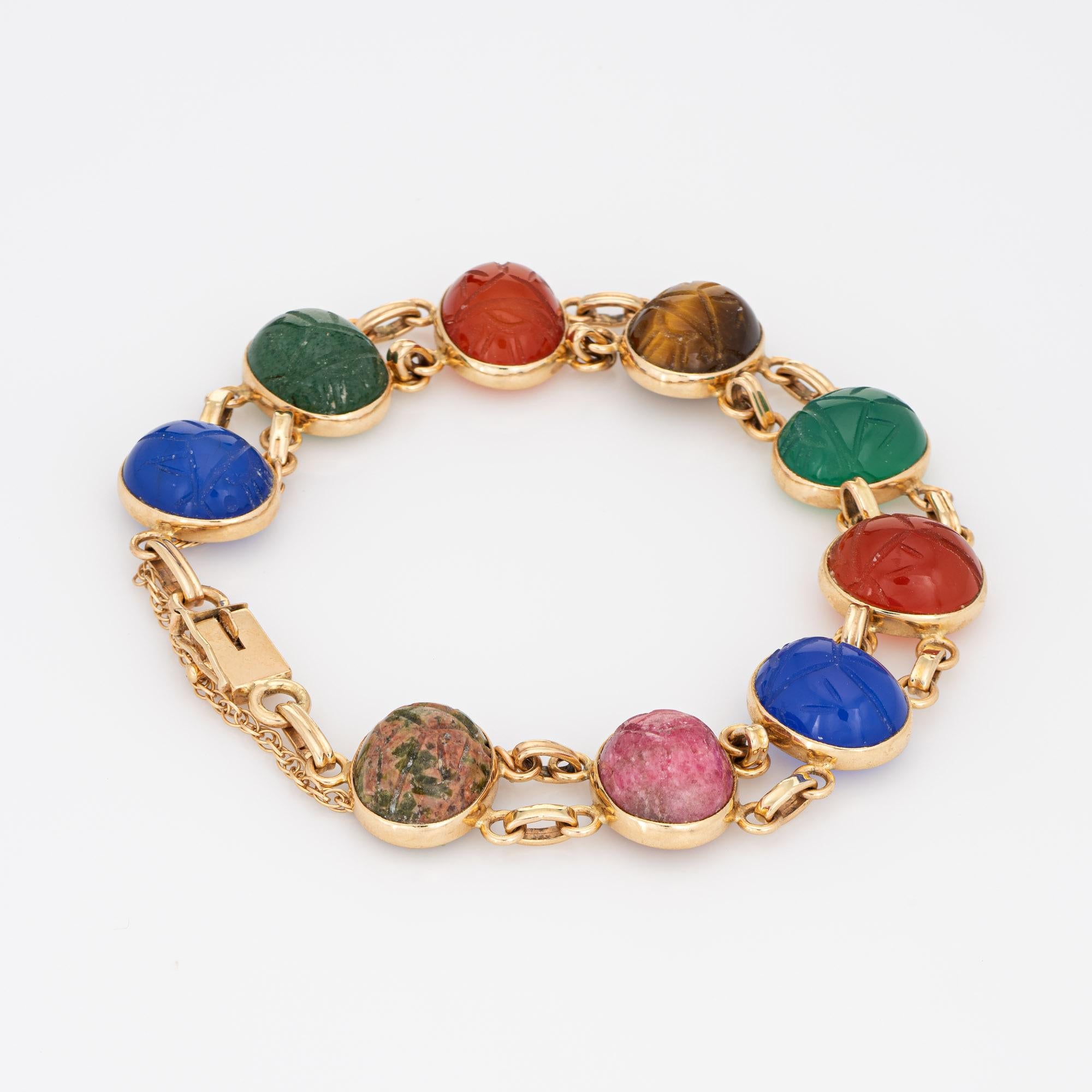 Stylish and finely detailed vintage scarab bracelet crafted in 14k yellow gold. 

Blue & green chalcedony, tigers eye, carnelian and rhodochrosite measure 12mm x 10mm. The stones are in very good condition and free of cracks or chips.   

The