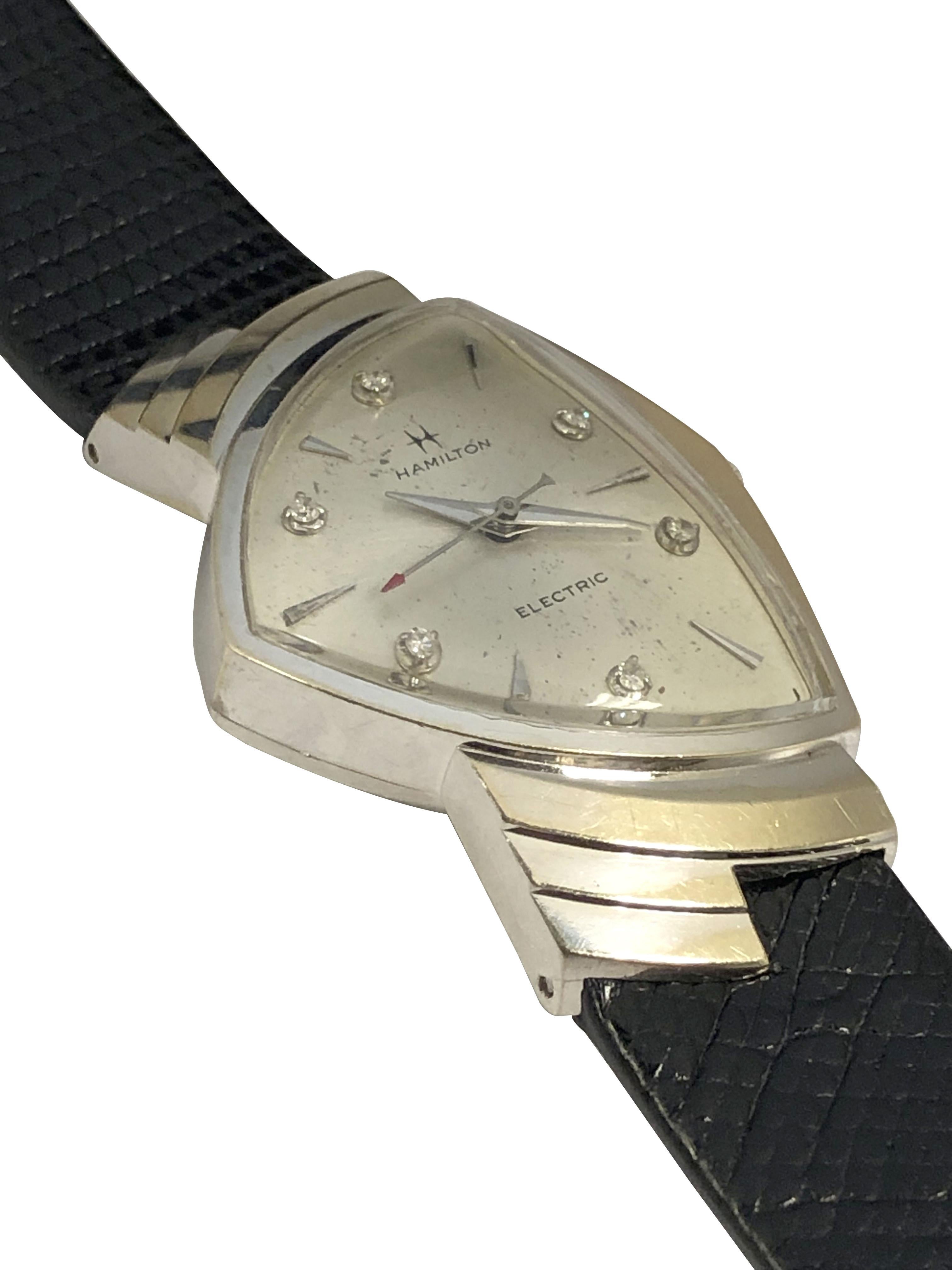 Circa 1960 Scarce and hard to find Hamilton Electric Ventura Wrist watch, 49 x 31 M.M. 2 piece 14k White Gold case with its eccentric flared lug tops. Hamilton 505 Electric movement, original and near mint condition Silver Satin dial with Diamond
