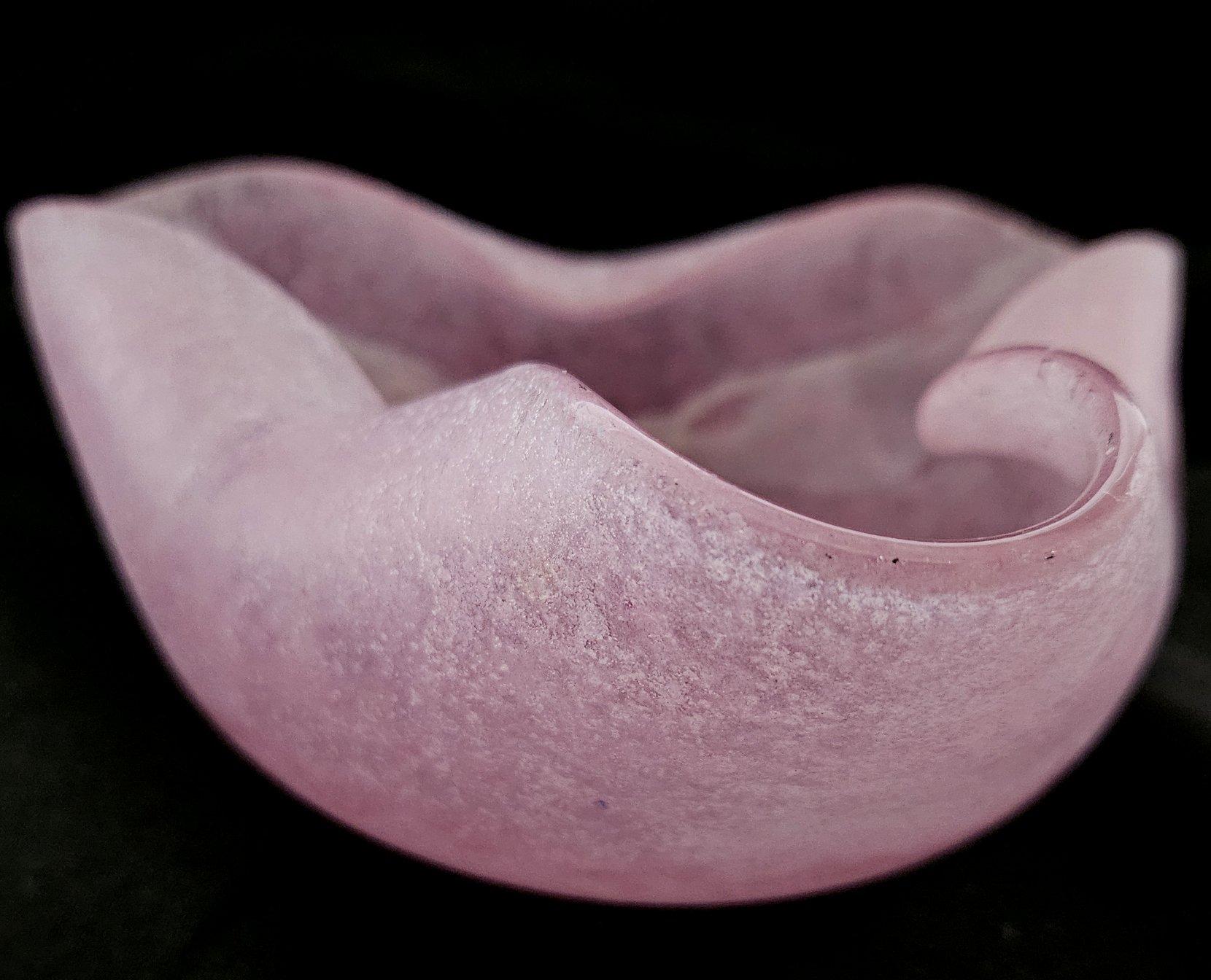 Vintage SCAVO Glass Bowl / Ashtray / Dish / Vide Poche

Measures: approximately 6.5 x 6 x 2.5 inches.
Color: Subdued pink tones with white and a few black spots (ash, most likely).

Measurements are approximate. Please be aware that the color on