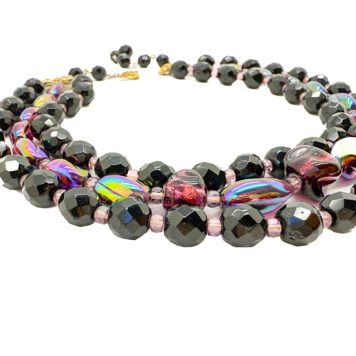 A beautiful Vintage Schiaparelli Amethyst Necklace dating to the 1950s. A design statement from this illustrious house featuring art glass and faceted beads in opulent hues of amethyst, pink and black. Creating a wonderful work of wearable art that
