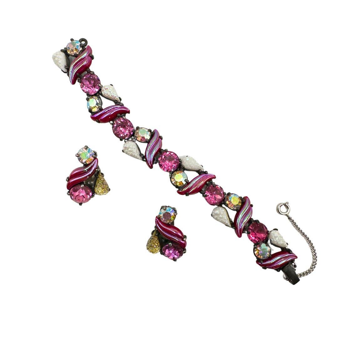 Bracelet Length: 7″

Earring Hight: 1.30″

Bin Code: E2 / P10

Indulge in the enchanting allure of our Elegant Vintage Schiaparelli Multi Color Glass and Rhinestone Bracelet & Earrings Set. This exquisite jewelry ensemble showcases the timeless