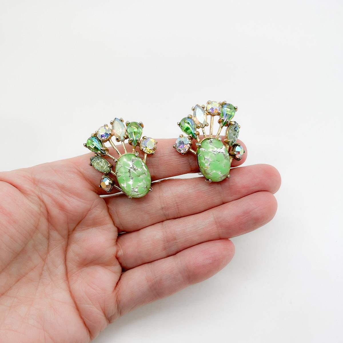 A pair of Vintage Schiaparelli Easter Egg Earrings. Exquisite vibrant easter egg stones surrounded by a fan of fancy cut crystals create this rare jewel. A decadent and adorable finishing touch like no other. As the Parisian House of Schiaparelli
