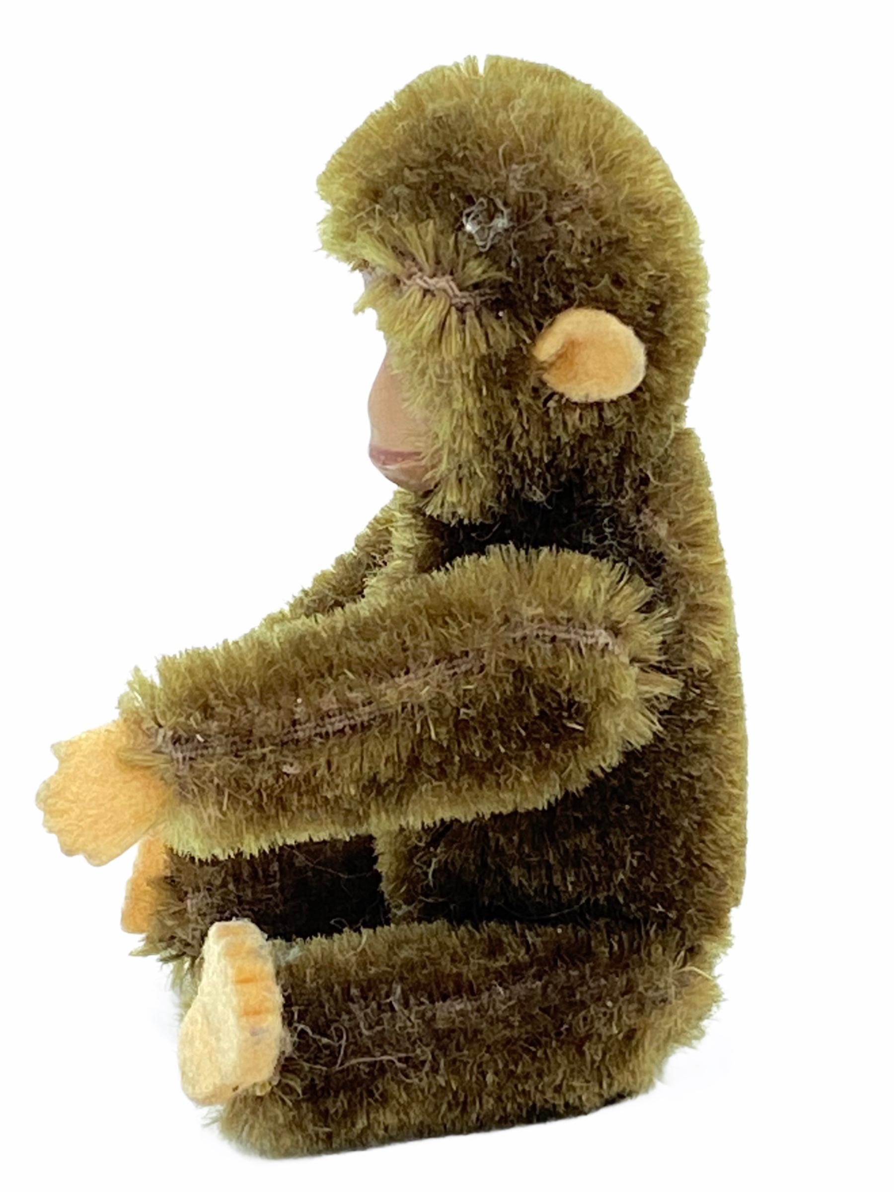 Very nice circa 1930s Schuco monkey with a striking painted metal face. Arms legs move and the head can turn left and right. Felt ears, hands and feet. Made in Germany by the famous Schuco Toy Company. It is in very good condition.