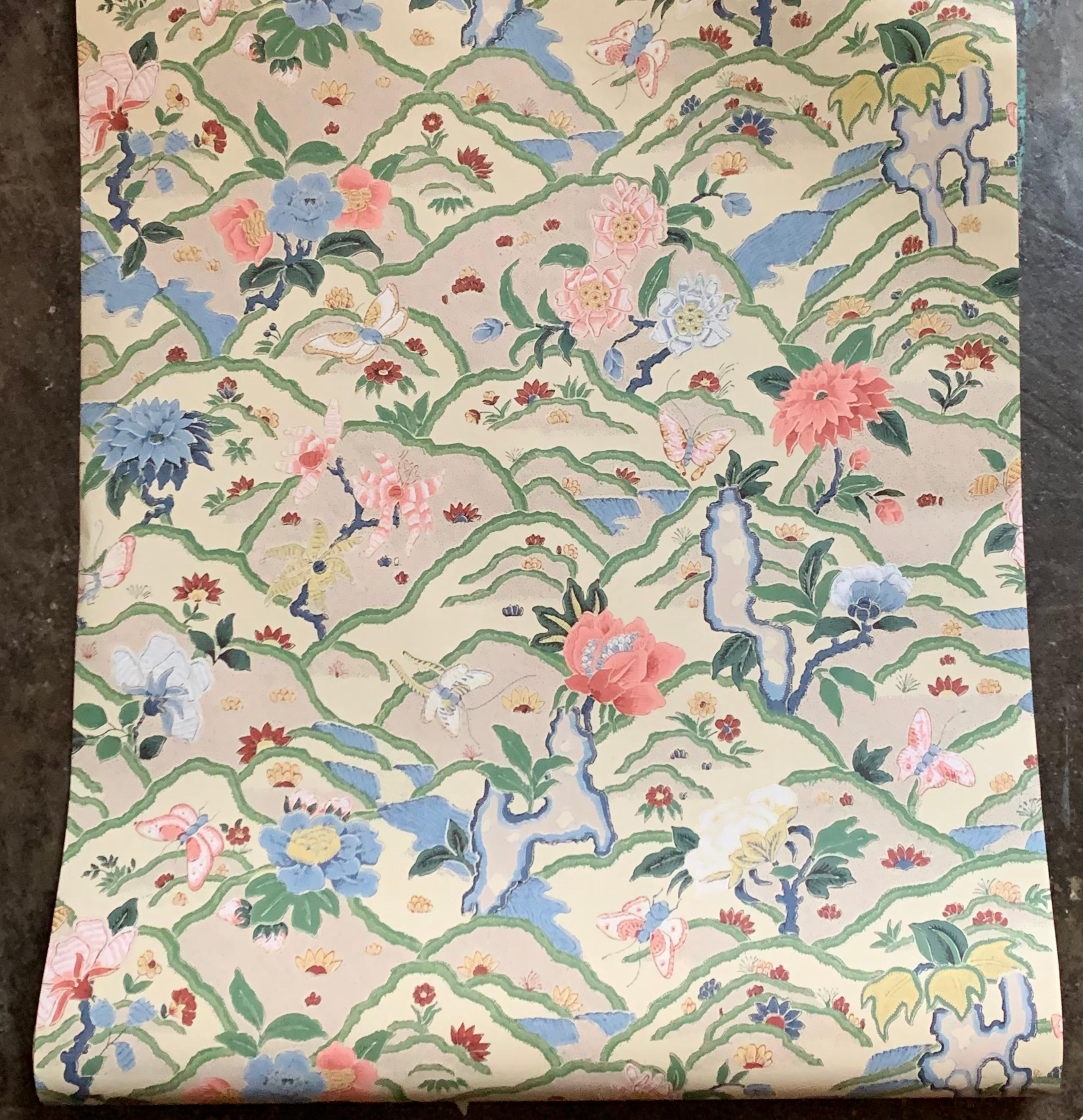 Vintage Schumacher Mendhar coral blue hand-print Anglo-Indian floral wallpaper. Pattern number 4714 A. Features Jacobean flowers, butterflies and bird’s-eye view of rolling hills with bodies of water. Sold by the double roll. Each double roll is 27