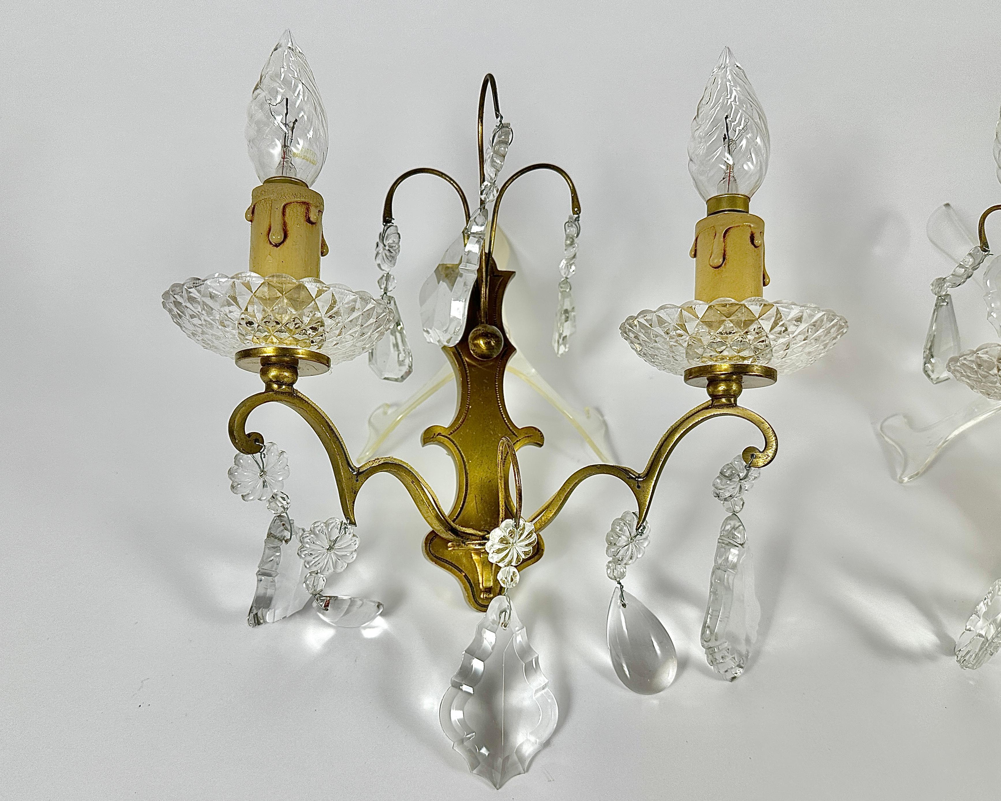 Vintage sconces bronze with gilding, crystal from France,  mid-20th century, each with two lamps, very beautiful and festive!

The crystal droplets are stunning, different shapes and sizes.

This is a lovely pair of gold tone bronze and crystal