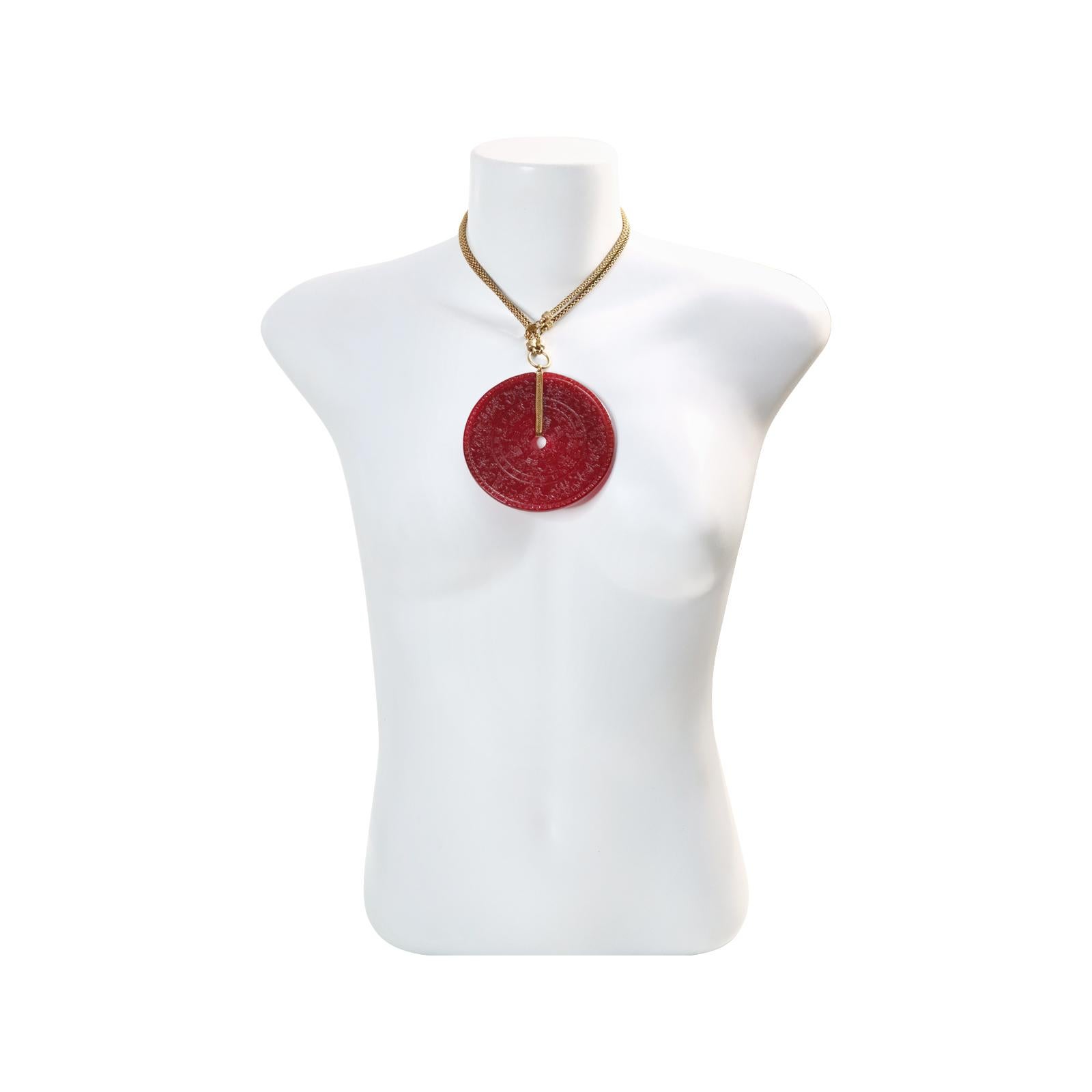 Vintage Scooter Paris  Red Resin Astrological Disc Necklace Circa 1980s. This chic necklace features a gold-tone chain and a red resin astrological disc.  That pop of red that everyone is talking about is here.  Red never goes out of style.  This
