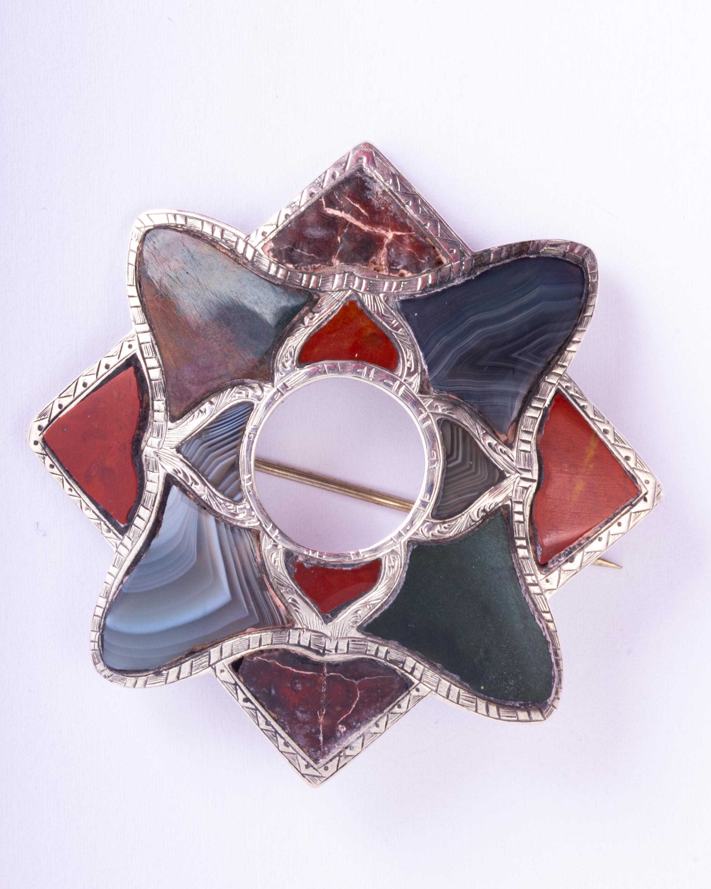 The agate in this brooch is so beautiful and has so many colours running through it with detailed silver frame. 

Brooch Dimensions: 56x56mm

Weight: 18.02g