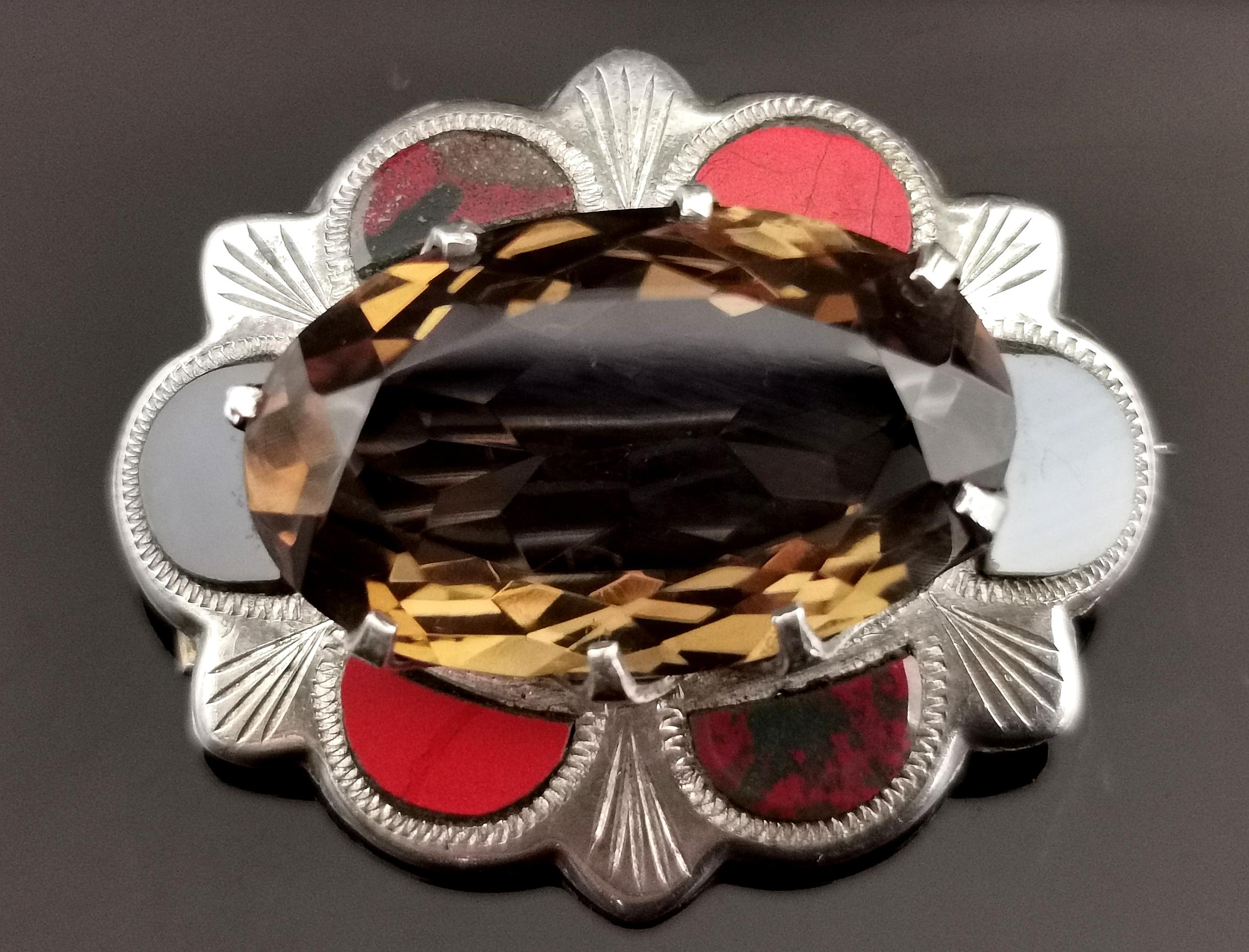 A gorgeous vintage Scottish sterling silver, agate and smoky quartz brooch.

Modelled on the designs of the Victorian Scottish agate pieces this attractive brooch is a scalloped oval shape, set to the centre with a large faceted oval smoky