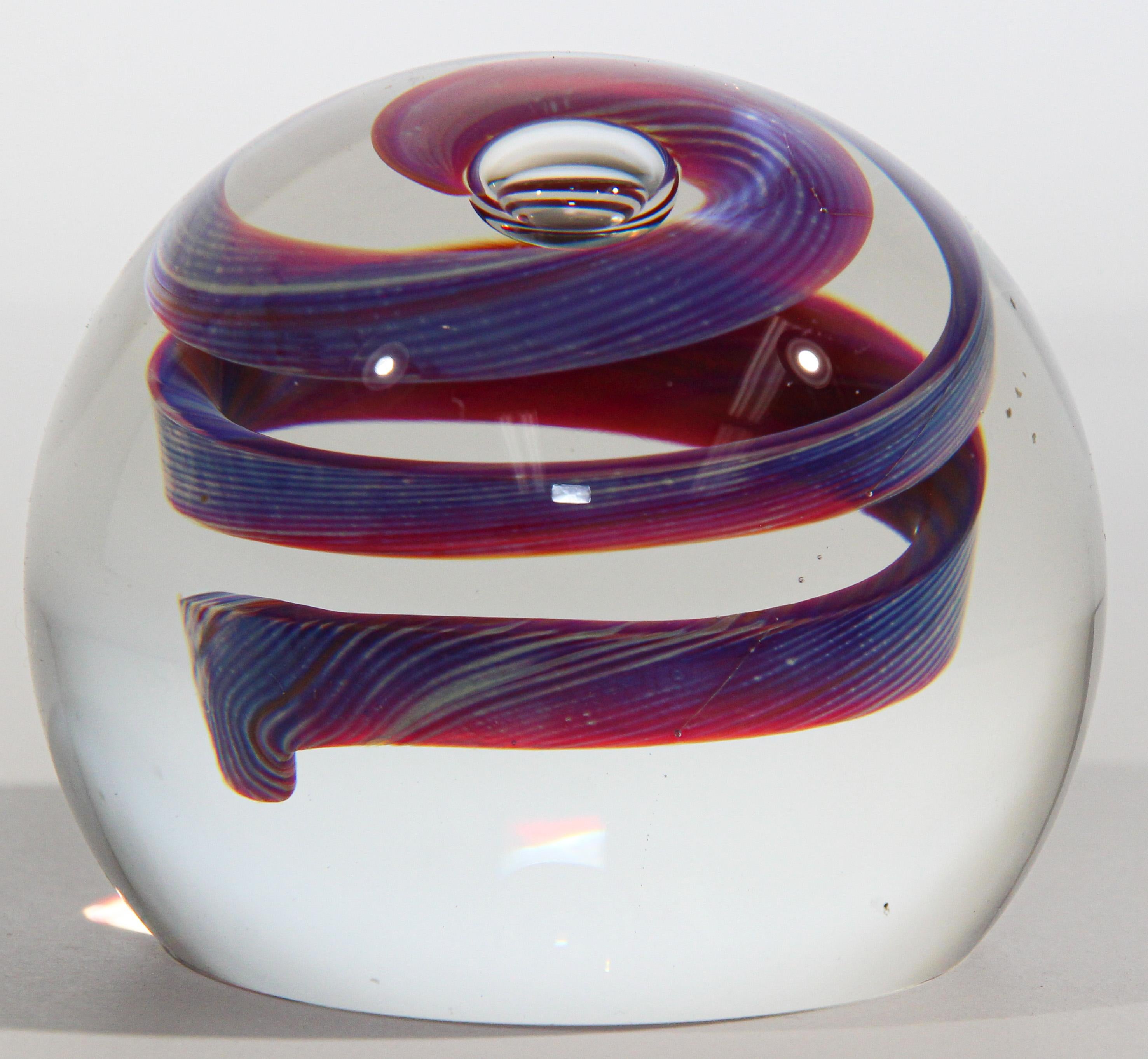 Gorgeous Vintage Scottish Art Glass 1999 abstract design paperweight. 
Beautiful pink and blue swirl paperweight. 
Colors are a blue, maroon, pink and clear. 
Engraved Glass Signed and dated 1999.
Hand made in Scotland
Diameter 2.5