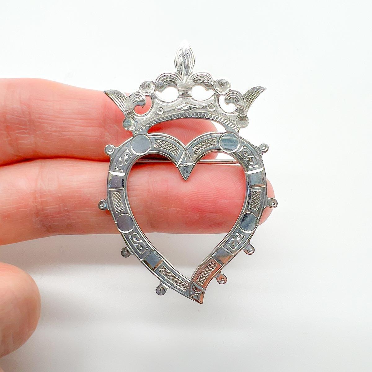 A Vintage Scottish Luckenbooth Brooch. Crafted in hallmarked Scottish Sterling Silver.
Luckenbooth brooches are traditional Scottish love tokens, usually heart shaped and often with a crown or coronet . These brooches were often given as a betrothal