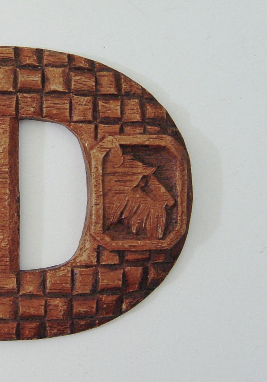 Circa 1940's buckle made to look like carved wood out of a tough wood composite developed by Syroco Co. used during the 1930's thru the 1960's. Scotty dog medallions on basket weave background. Fits a 1.25