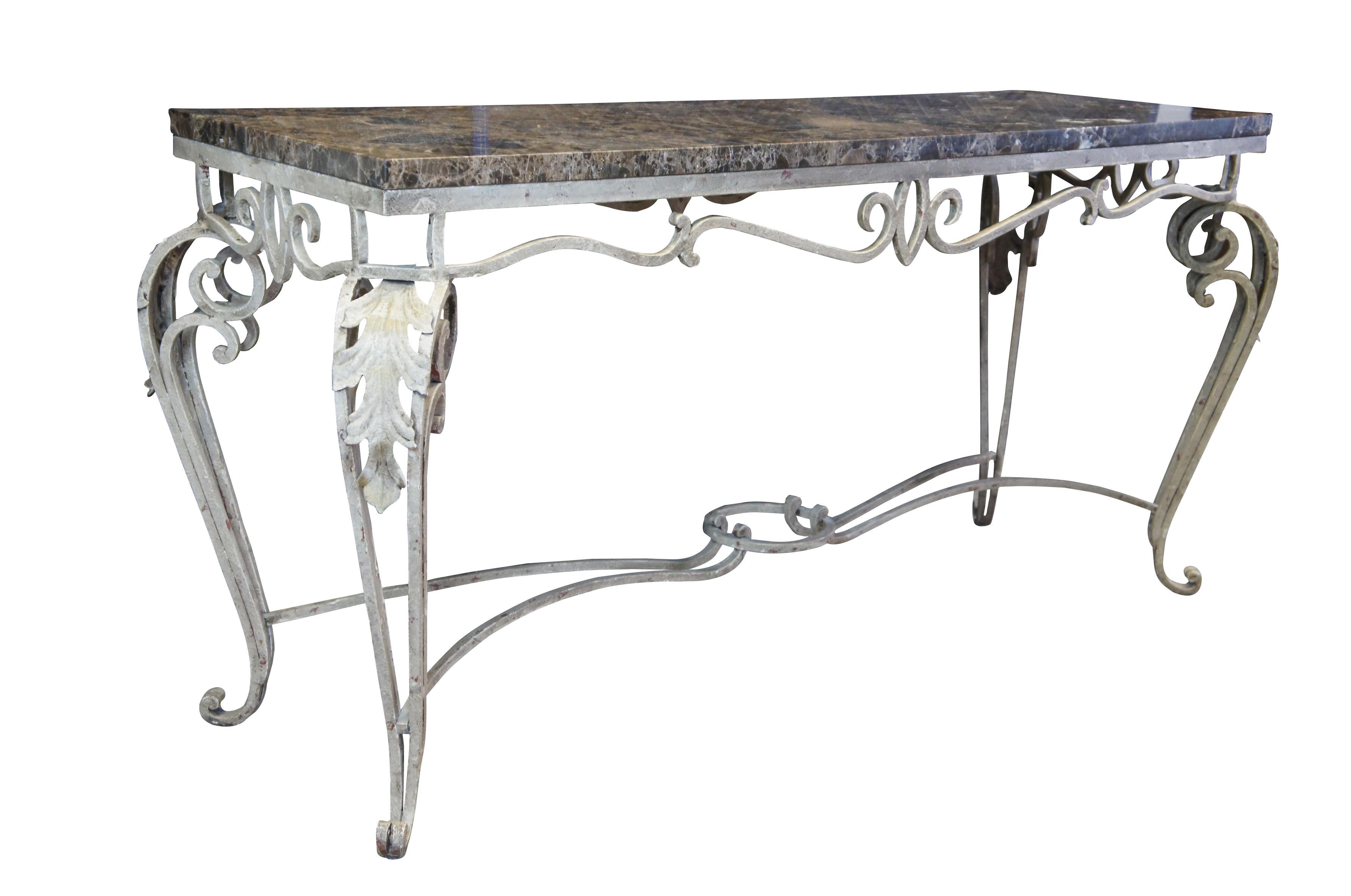 A lovely scrolled iron console table with Spanish marble top.  Features a rectangular form with serpentine skirt and cabriole legs with acanthus design along the knee.  

Dimensions:
23