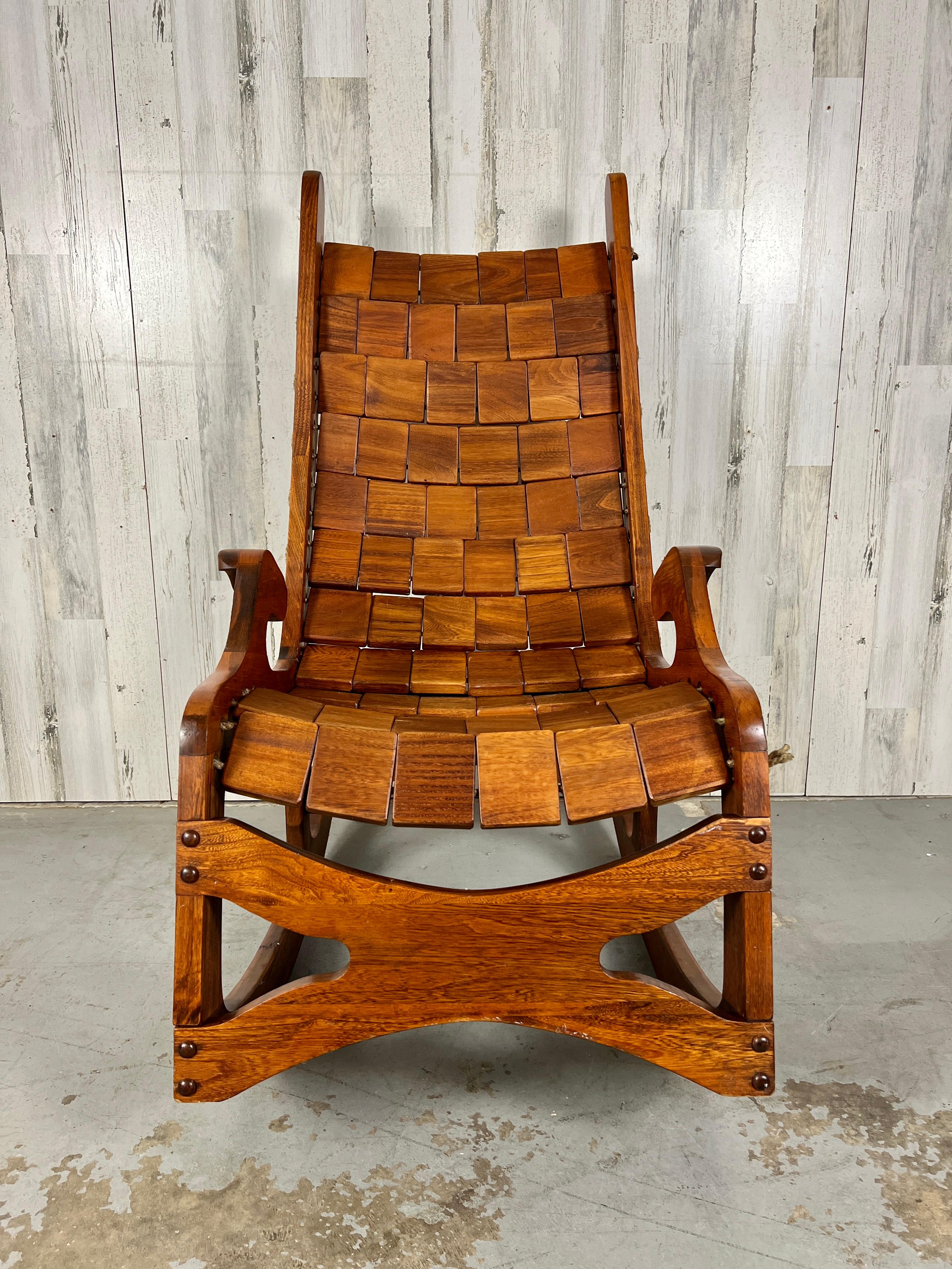 Let the rest of the world go by rocker by Top Notch Industries. Hand crafted patchwork walnut strung together with rope. Very comfortable and stunning for any room of the house.