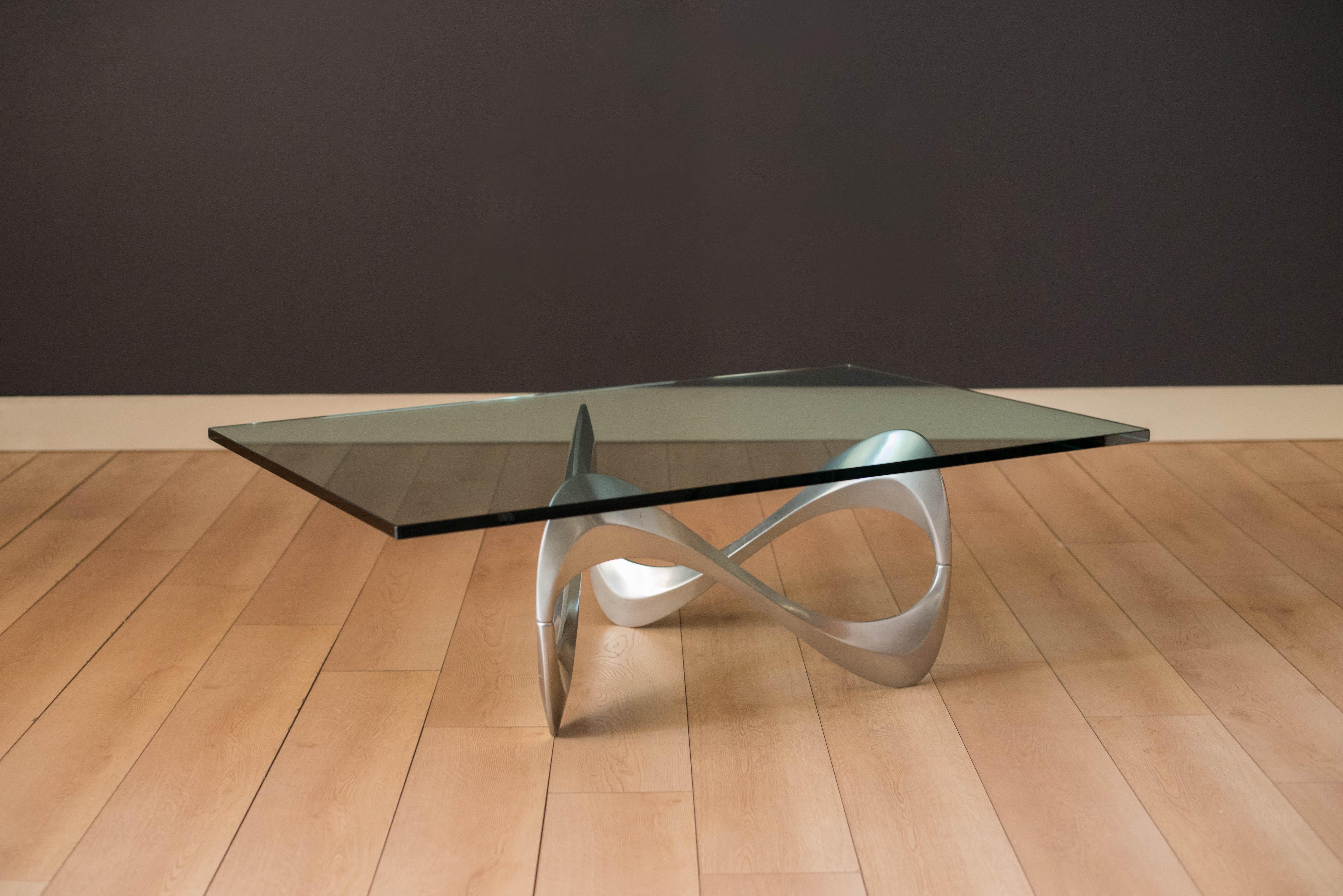 Vintage 'snake' coffee table by Knut Hesterberg for Ronald Schmitt, circa 1960's. This piece features a sculptural aluminum base that showcases from all angles. Sturdy rectangular glass top adds transparency creating depth to any space. Also,