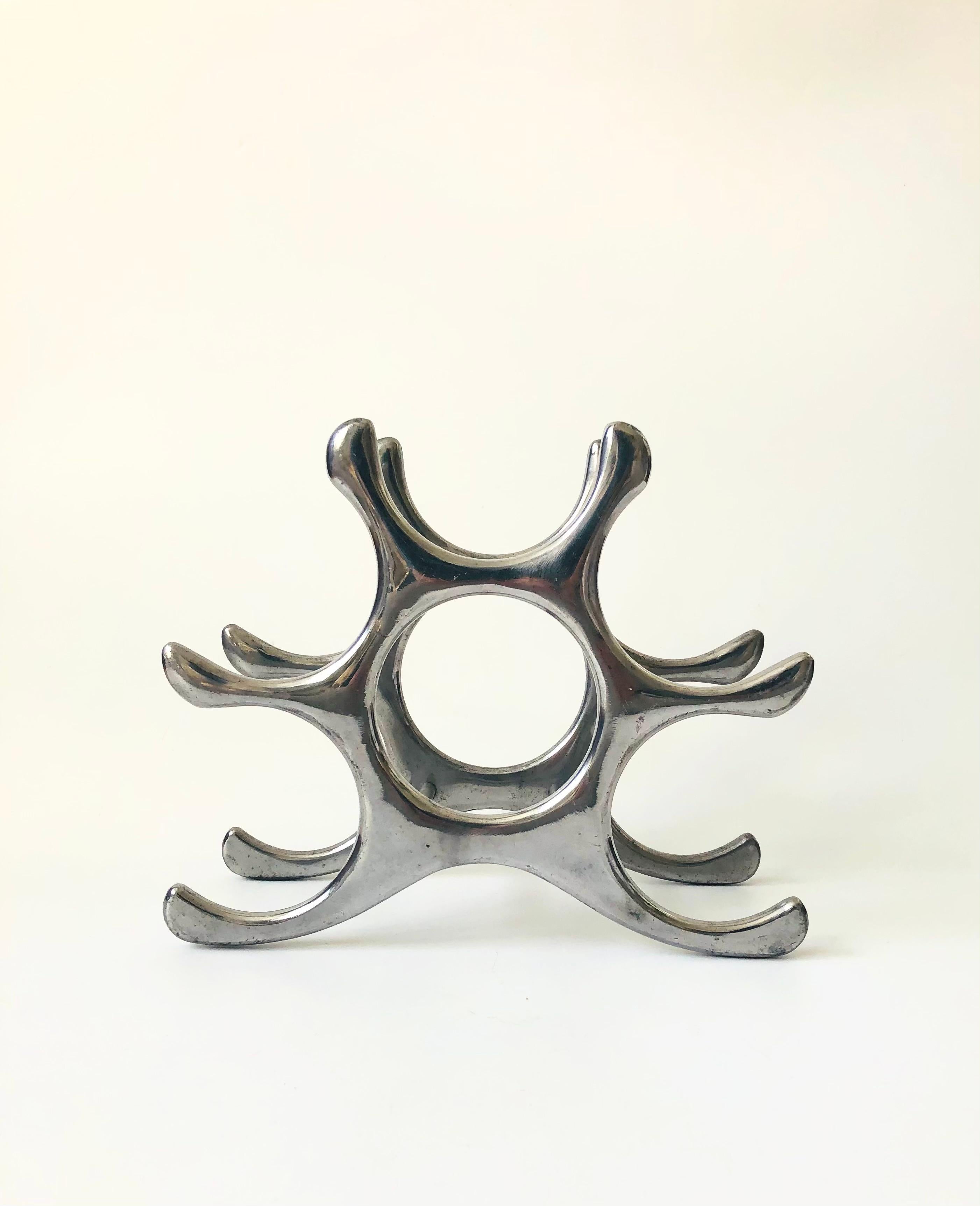 A vintage aluminum wine rack designed by Michael Noll. Great sculptural shape that can hold up to 6 bottles.

