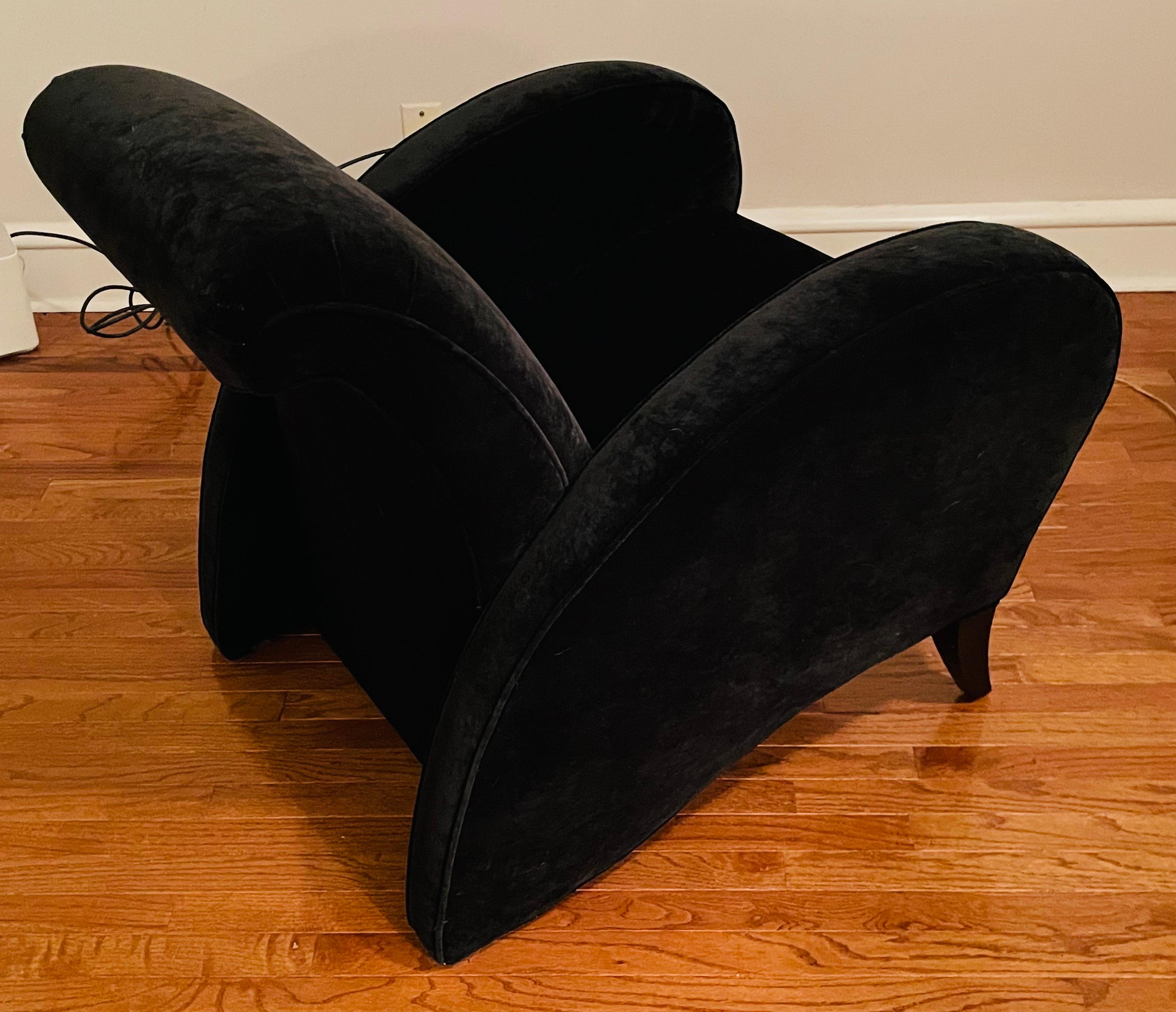 This is a large, sophisticated lounge chair, having an Art Deco silhouette. The gracious, soaring arms add that Deco drama.

It is generously padded, and is currently upholstered in a rich black velvet.

If you need a corner chair that can offer