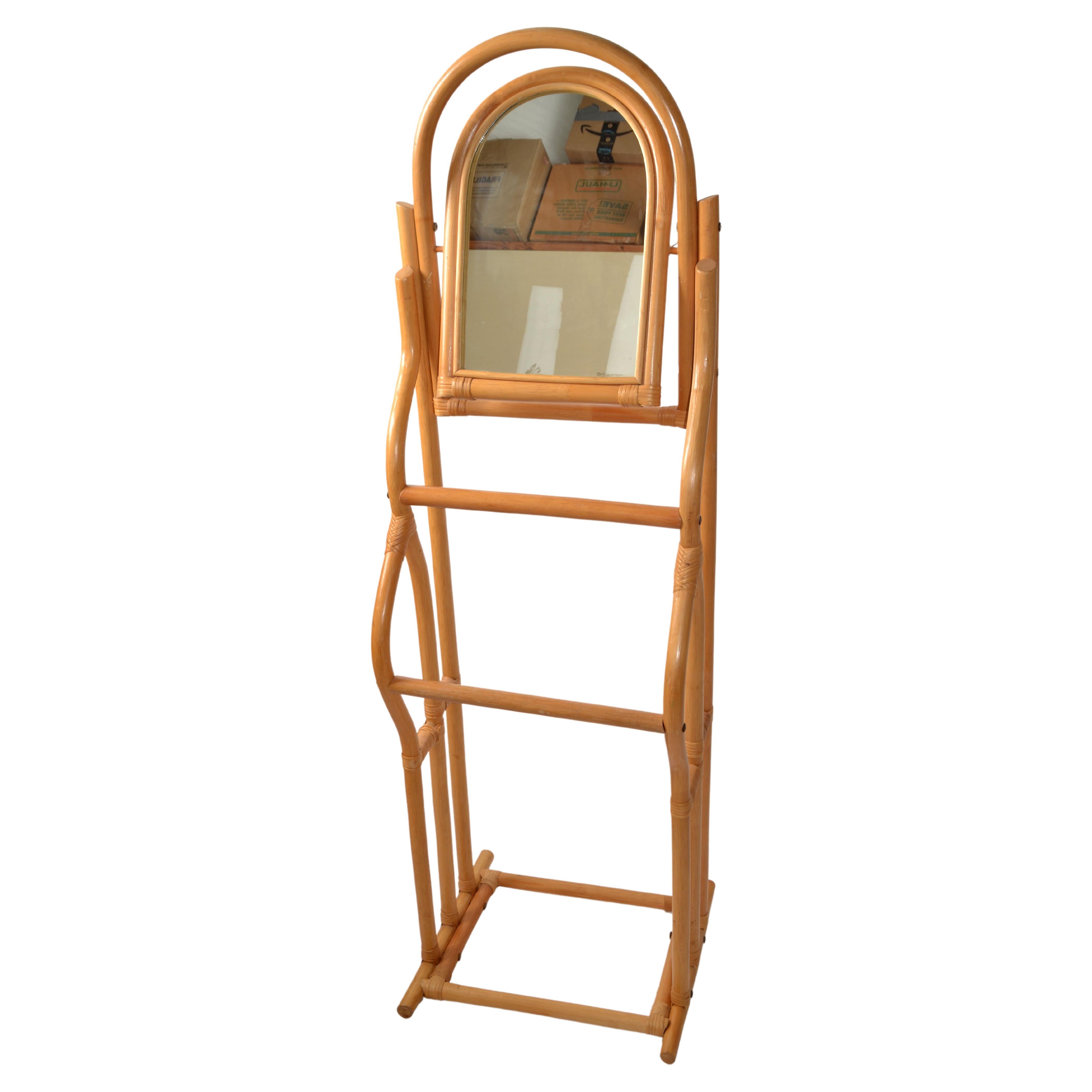 Late 20th Century sculptural Bohemian Chic Hand-crafted Bent Bamboo Valet Stand with Mirror.
Features Bamboo framing with Bindings of Cane, two Bars for hanging Clothes and a flexible arched Mirror.
Brass Hardware to provide a firm foundation.
In
