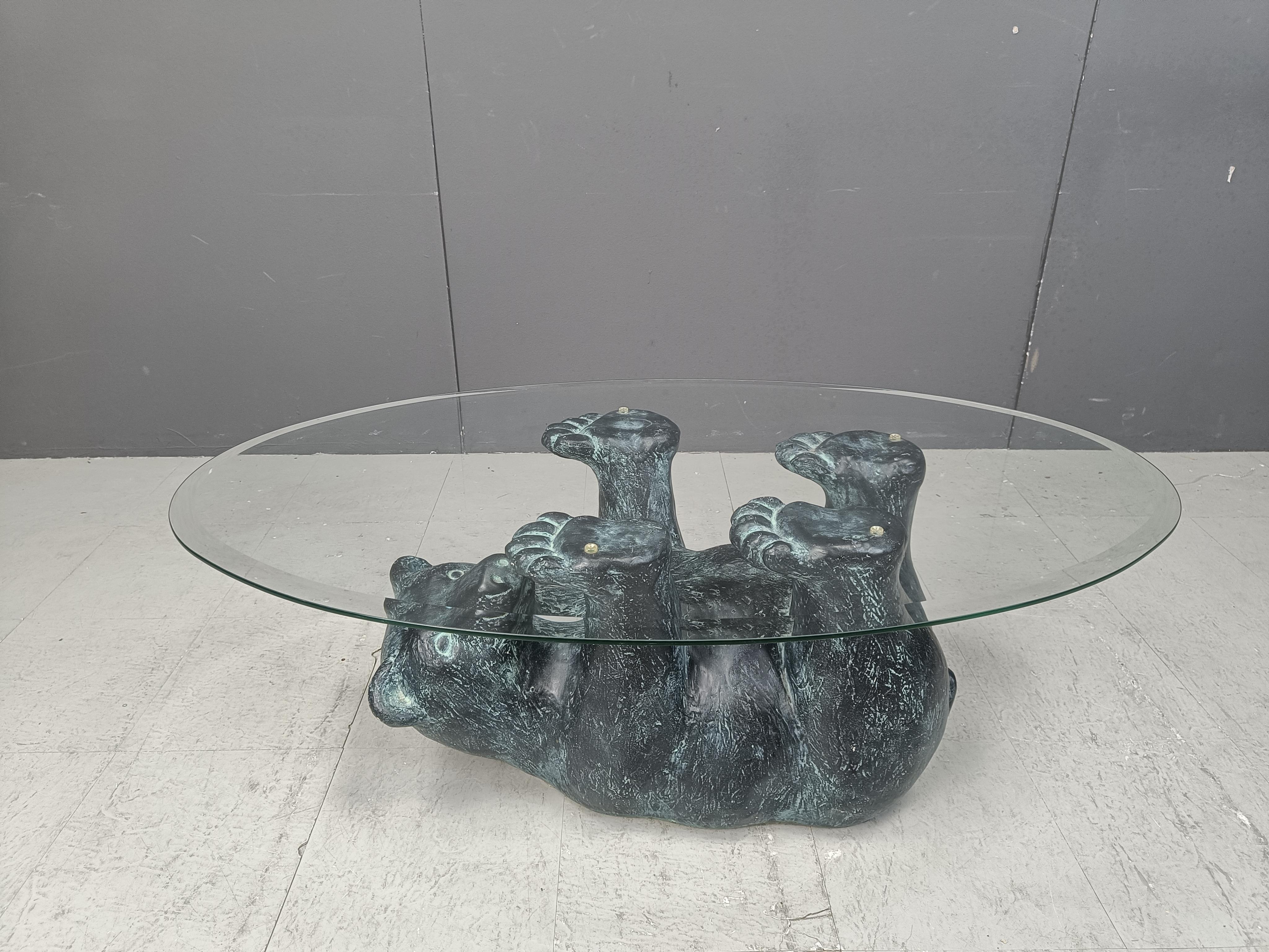 Eye-catching sculptural black bear coffee table.

This unique table looks great and somewhat cute.

Beveled oval clear glass top

1970s - Belgium

Good condition

Dimensions:
Hieght: 43cm
Depth: 64cm
Length: 112cm

Ref.: 25011404