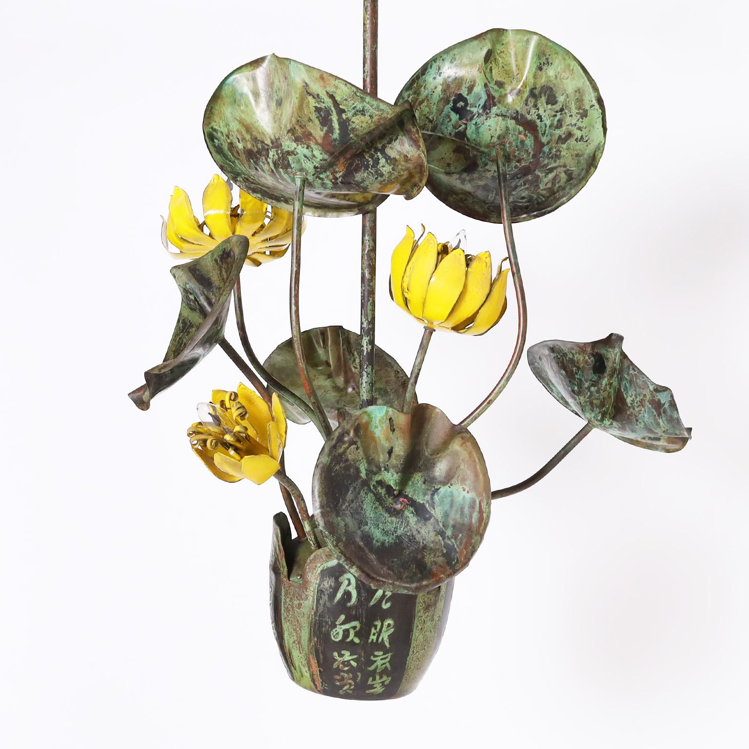Standout Asian modern sculptural chandelier crafted with verdigris copper in an organic composition of leaves and enameled flowers in a pot with characters. Signed Garland on top of the pot.
