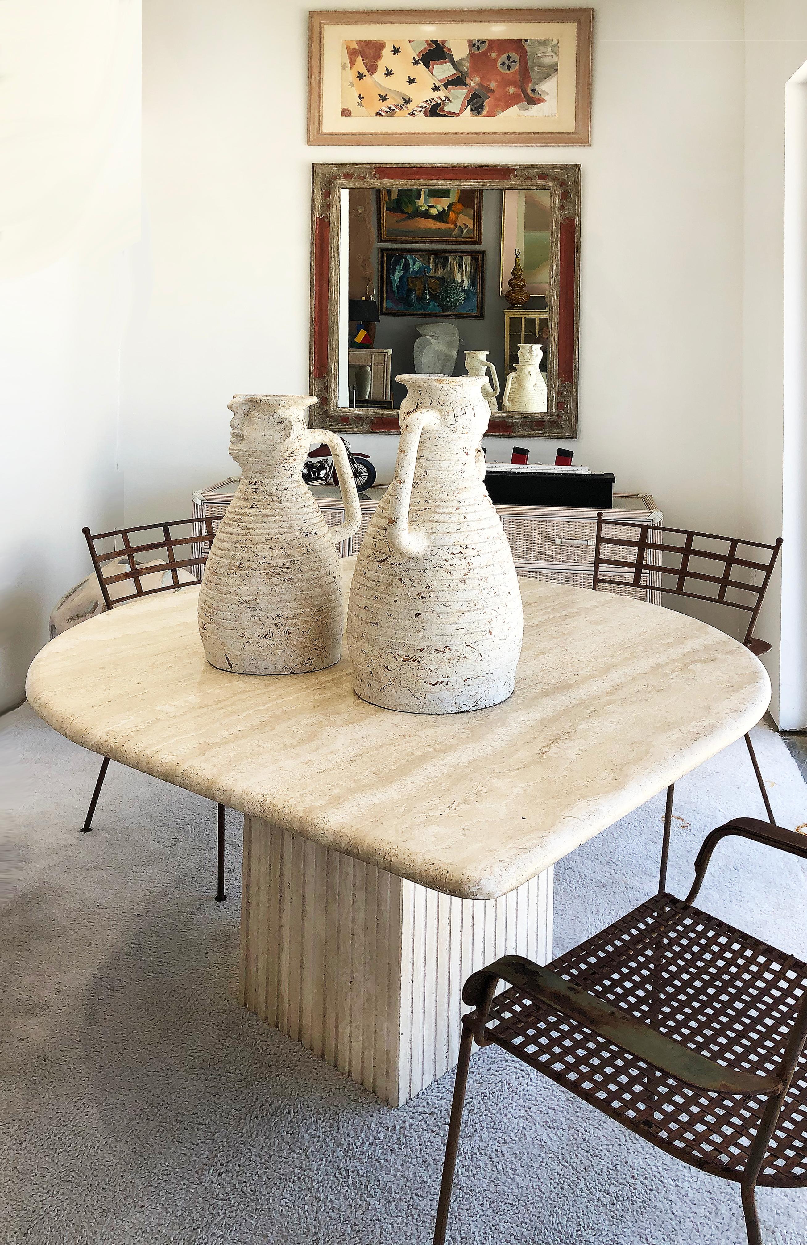 Vintage sculptural Brutalist travertine dining table, Italy


Offered for sale is a unique-shaped travertine stone pedestal base dining table. The travertine top has exquisite graining on the stone. The square base has a patterned finish. The top