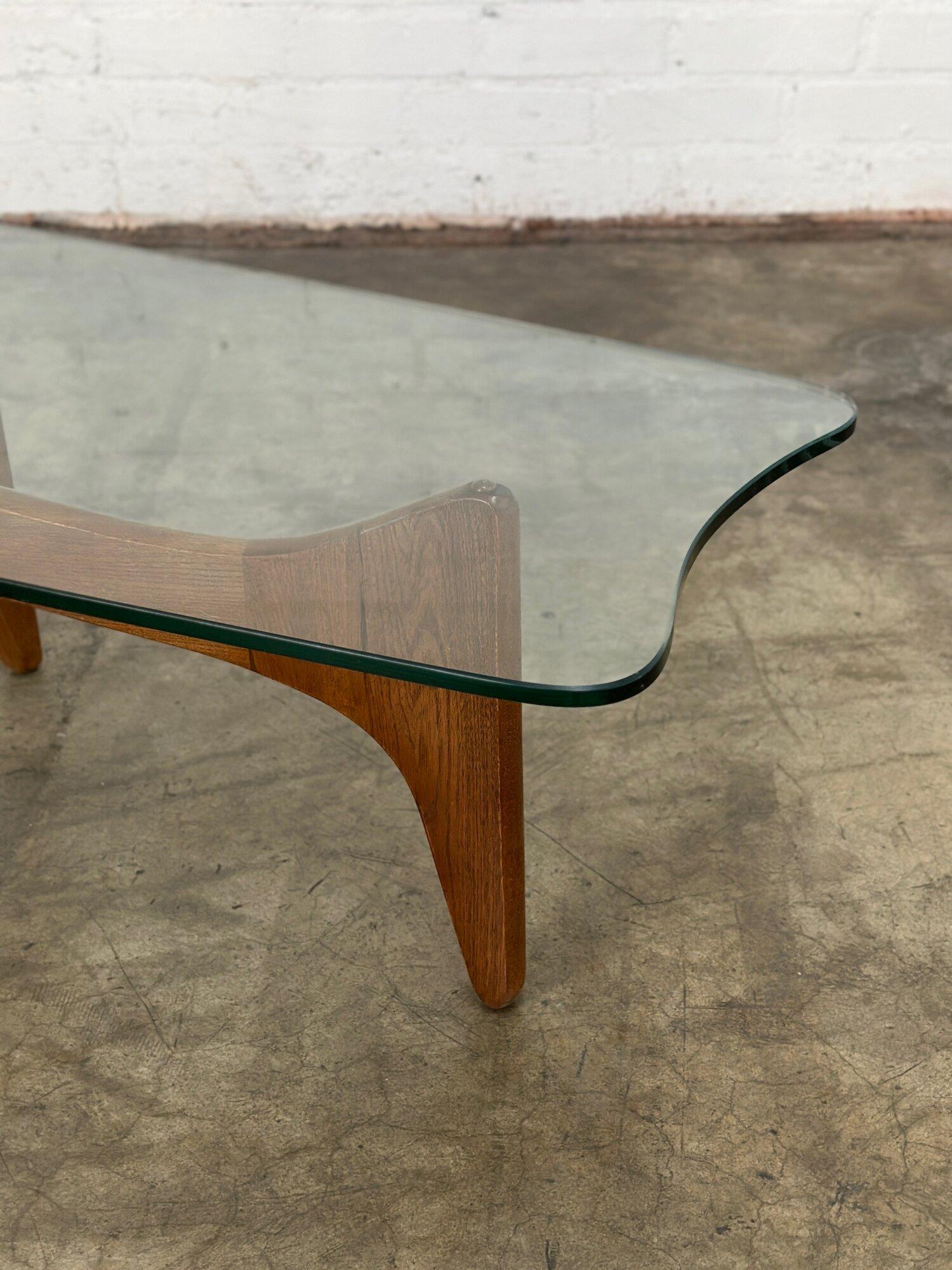 W59.5 W57 D20 H16

Refinished oak and glasss coffee table in great condition.  Oak has been done in a light walnut finish. Item features a great sculpted glass and an angular wooden base. Glass has no visible chips or breaks.