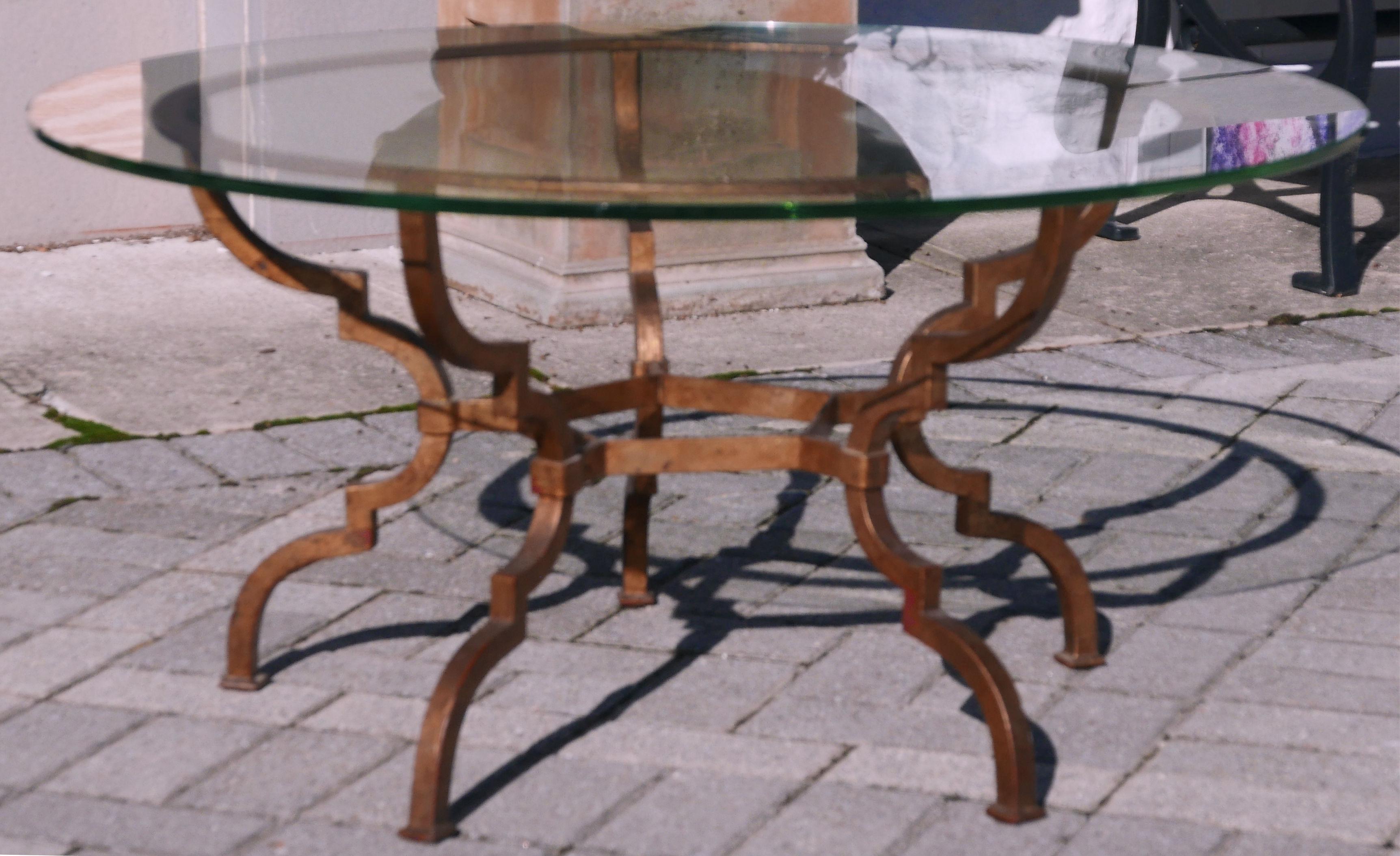 Stunning classic gilt iron coffee table similar in style to a design by Adnet made by Gilbert Poillerat from the same period. Original green edge glass in very good original condition.