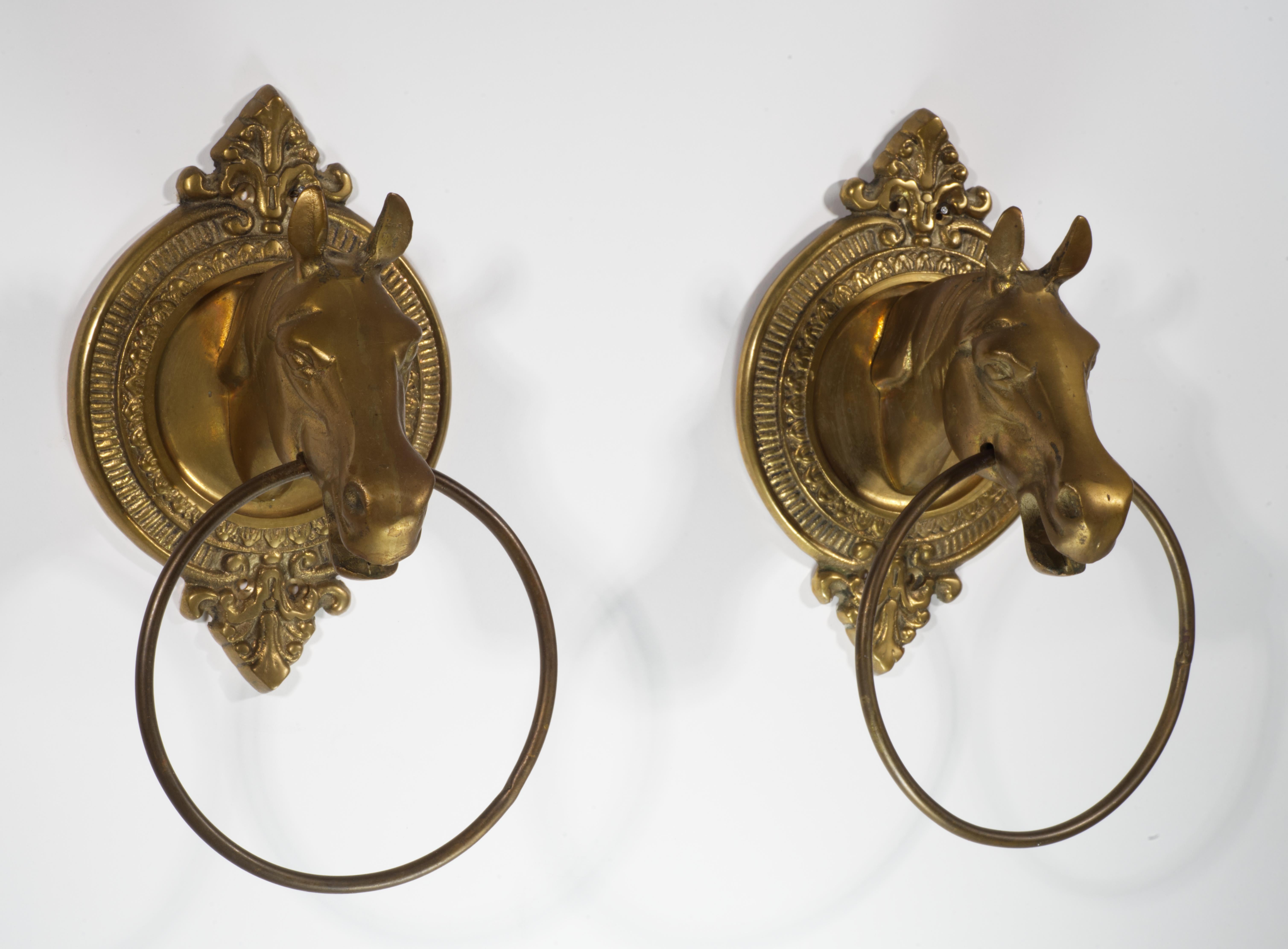  Pair of vintage towel rings feature sculptural horse heads mounted on intricately detailed round brass plaques.

The pieces are in good vintage condition with beautiful, age-appropriate patina on the brass; they can be securely wall mounted using