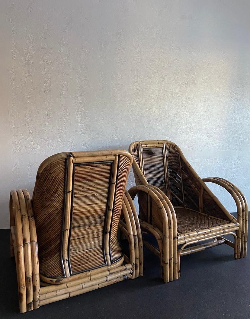 Rare pair of oversized pencil reed and rattan lounge chairs. The heavy rattan frames are complimented by Fine pencil rattan details and intricately woven cane seats. Matching sofa available on separate listing.

Would work well in a variety of