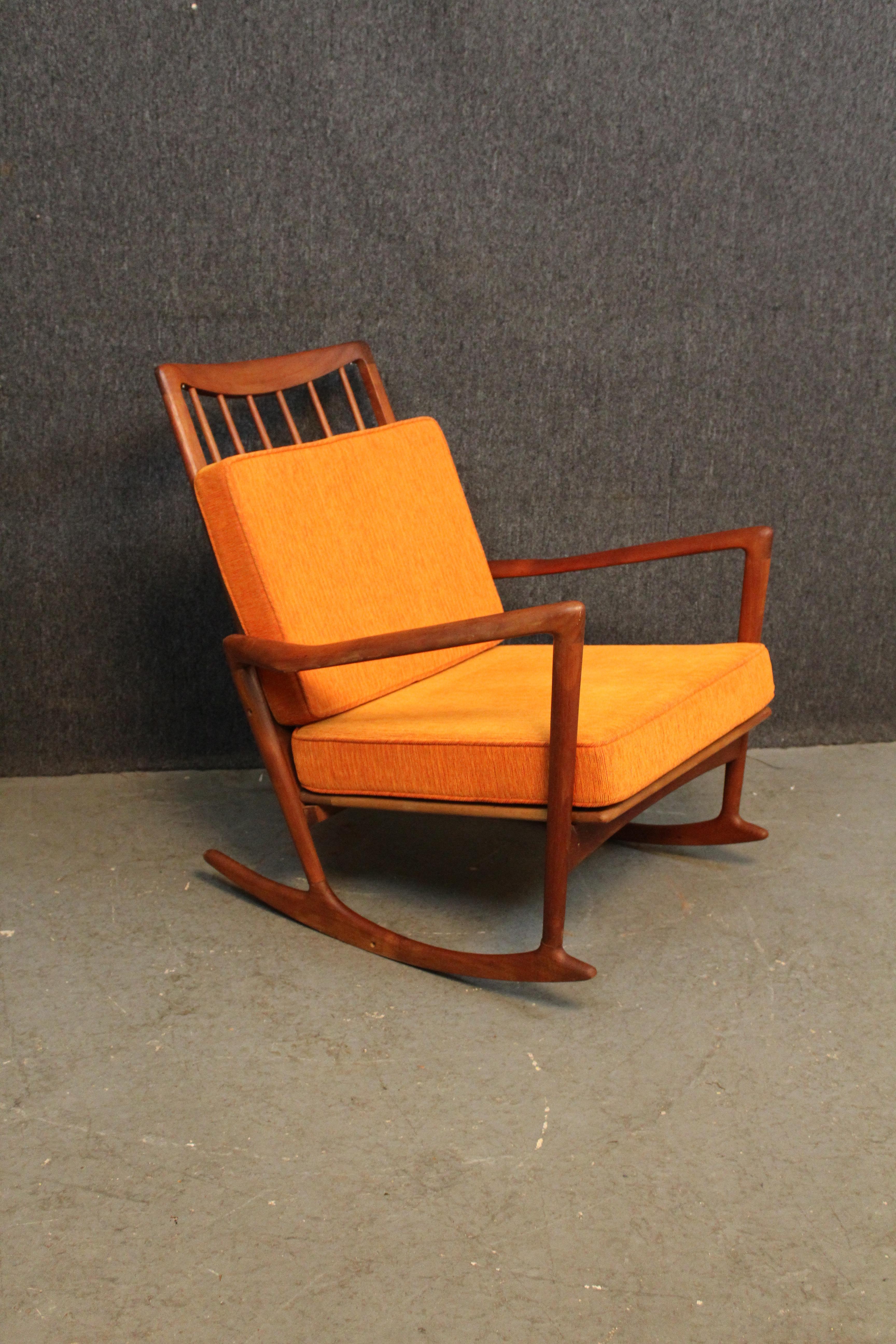 Bring home an iconic chair from one of the biggest names in Mid-Century Scandinavian Modern design with this breathtaking sculptural rocking chair made by Ib Kofod-Larsen for Selig of Denmark. With it's tall, spindle back, splayed boomerang