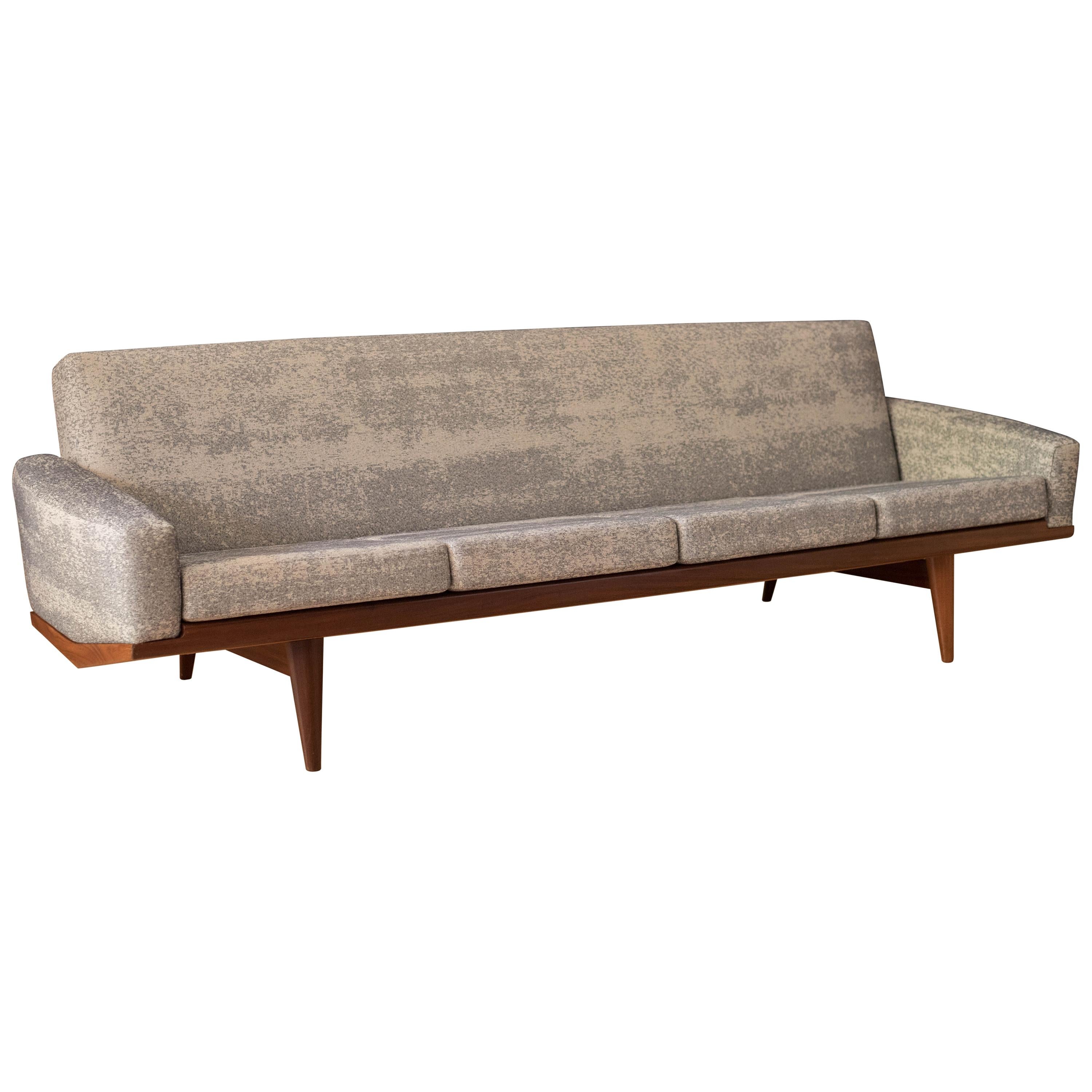 Mid-Century Modern four-seat sofa designed by H.W. Klein for N.A. Jørgensens Møbelfabrik, Bramin. This statement piece features a sculptural teak frame that displays well from all angles. Cushions are supported by original sinuous springs throughout