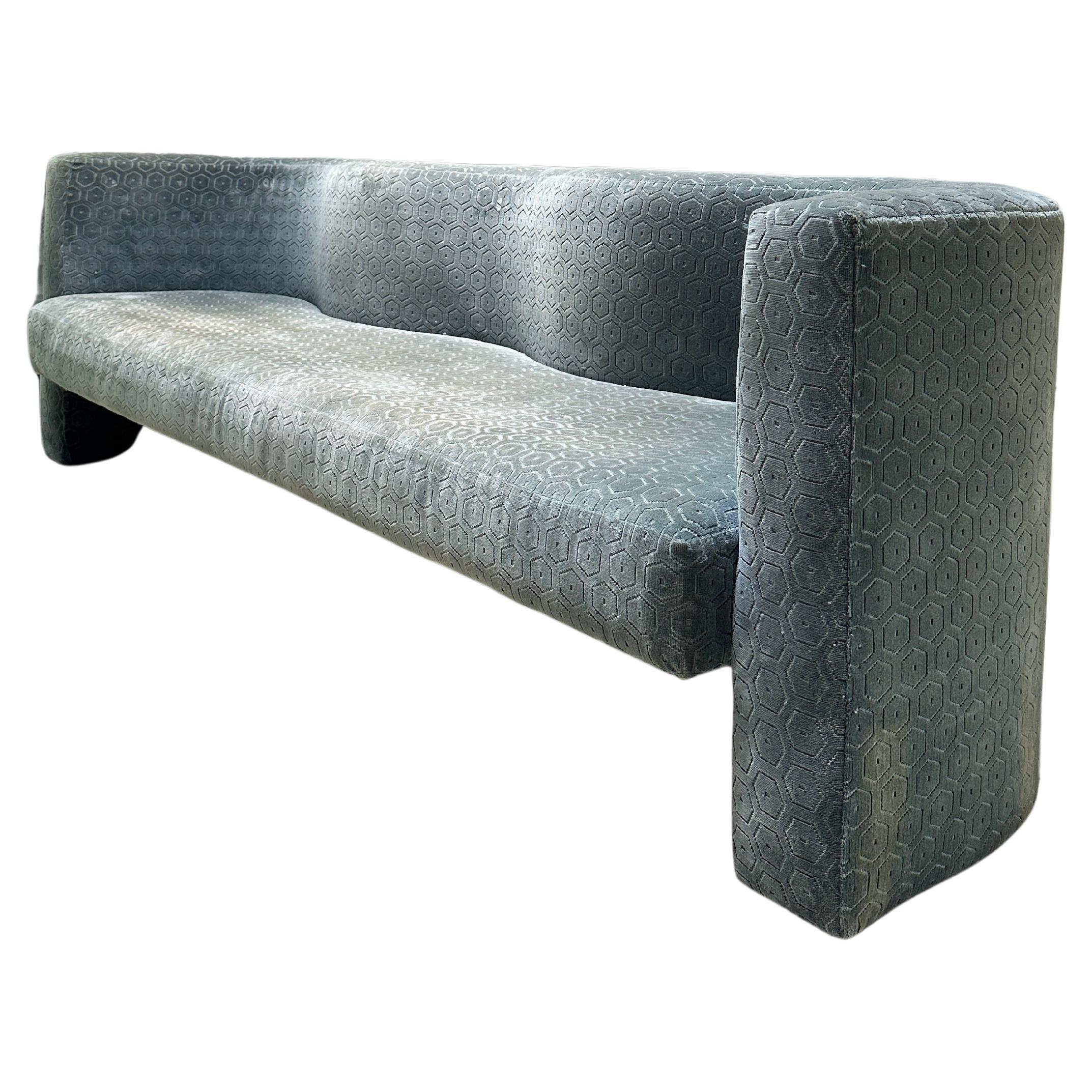 Post Modern Sculptural wave sofa. The three seater features a curved back and original teal hexagonal velvet.

Sturdy piece, some small discoloration on bottom back corner as seen in picture.

90’W x 26”D x 29”H x 17”Seat H