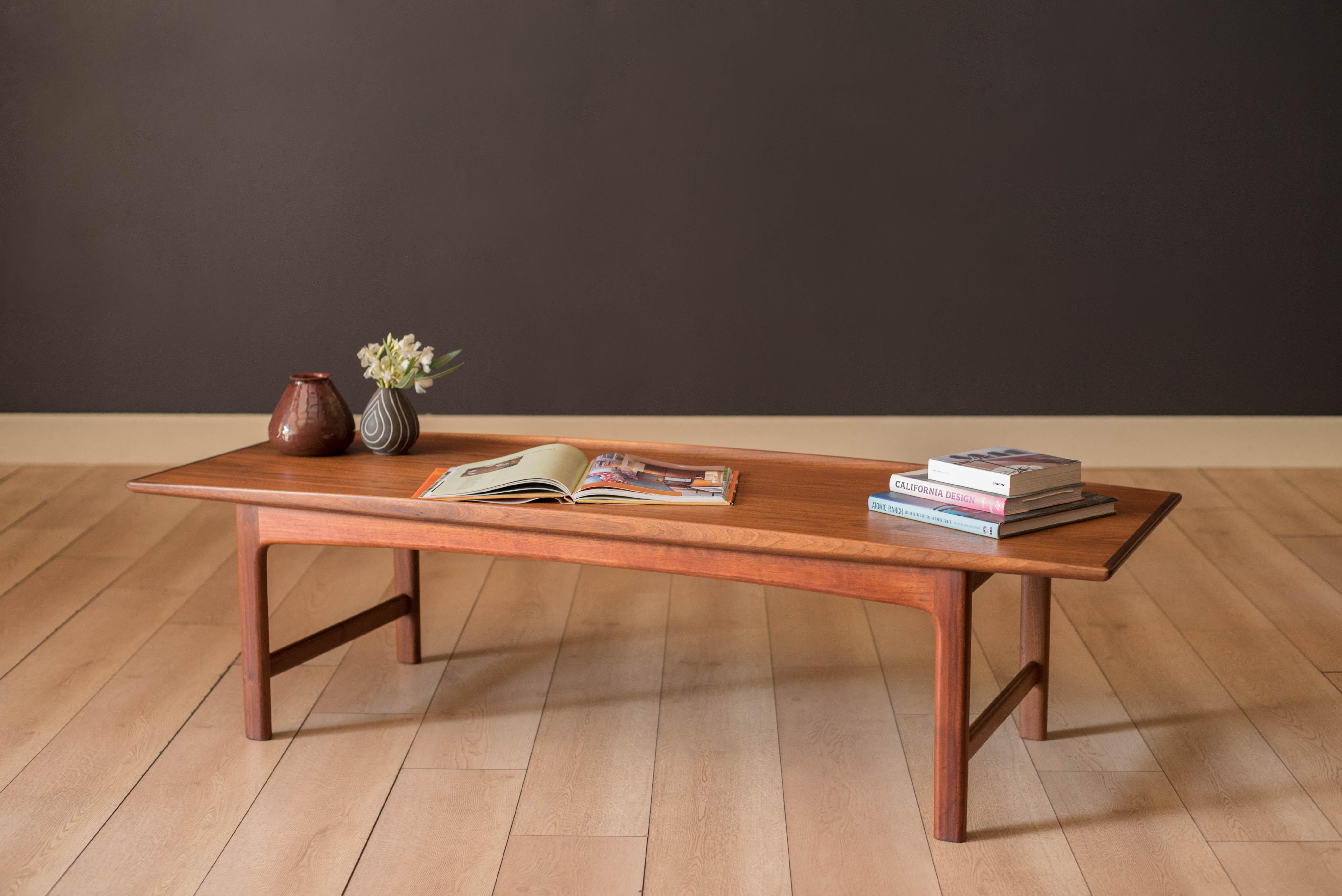 Mid century modern coffee table in walnut designed by Folke Ohlsson for DUX, Sweden. This classic piece features a warm natural wood grain pattern and raised sculpted edges. Supporting base is constructed with sturdy solid walnut legs. The perfect