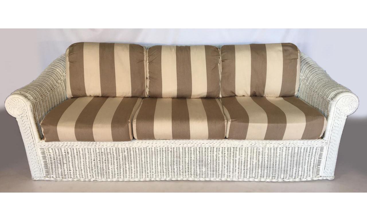 White wicker sofa features full wicker body and big comfortable cushions. Wicker frame is solid and in very good condition. Cushions have no stains, tears, or odors.