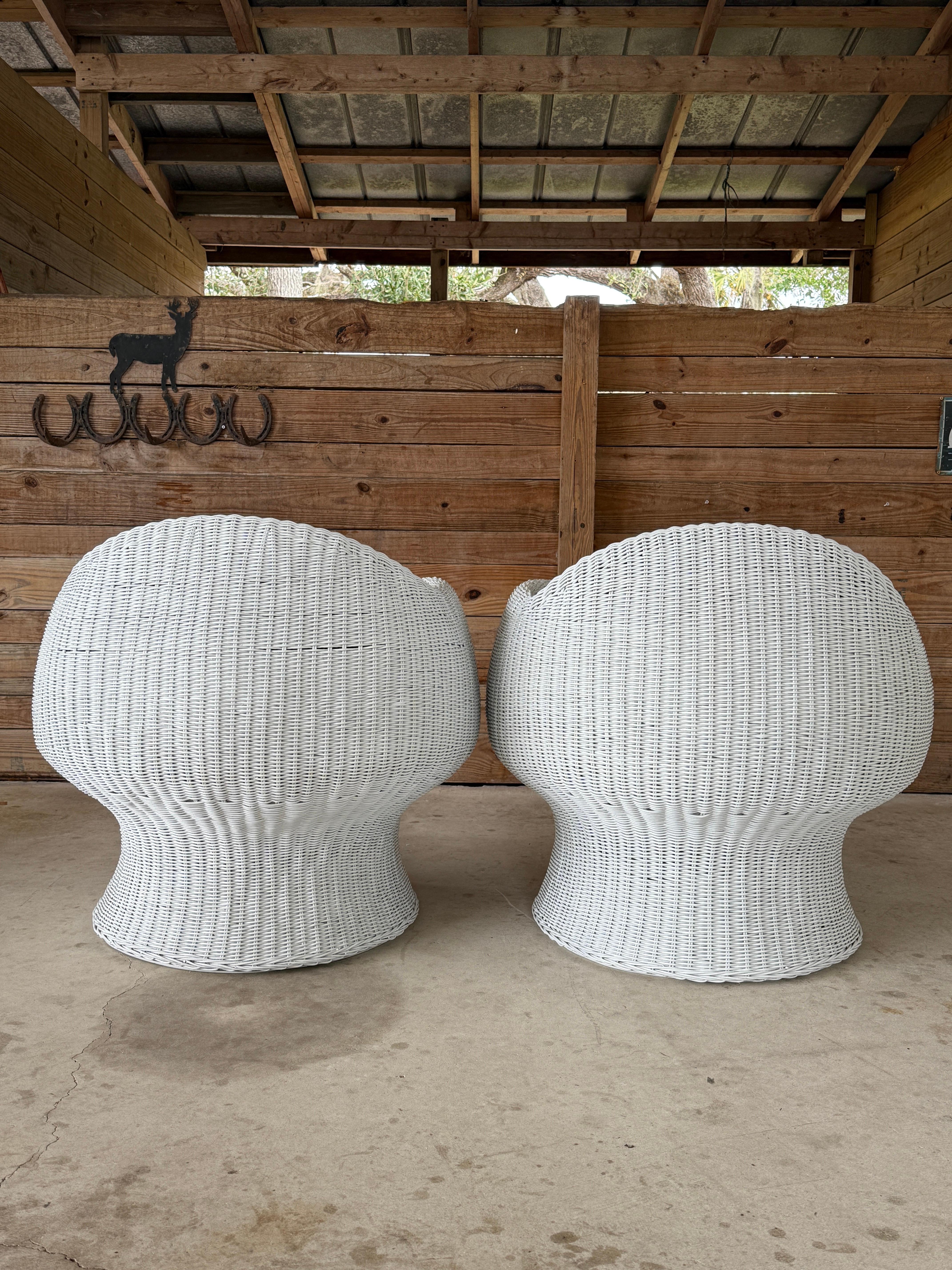 This captivating pair of vintage wicker barrel chairs channels the iconic sculptural design of Eero Aarnio.
The curvaceous silhouette features a painted white wicker frame with a bold, sculptural presence that makes these chairs perfect for adding a