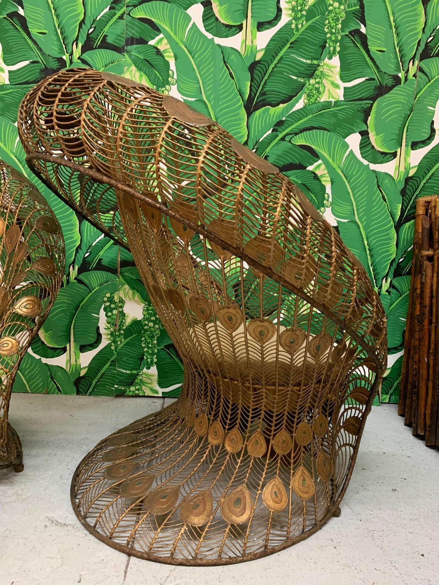 Pair of vintage steel club chairs feature sculptural form mimicking both a peacock's collapsed tail feather train as well as the feathers erect and on display. Very heavy and well constructed, frames are welded from wrought iron and include