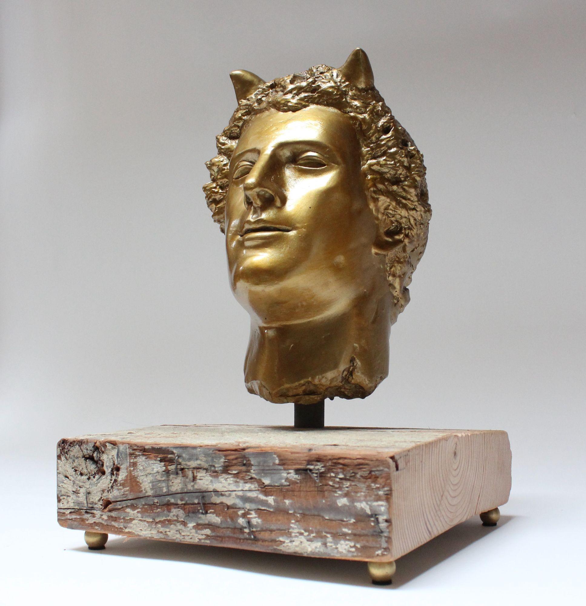 Impressive plaster cast of the mythological deity, Pan, finished in gold paint and mounted via a steel rod to a wooden plank supported by brass orb feet (ca. 1970s, USA).
Very good, lightly condition restored (gold paint has been lightly touched