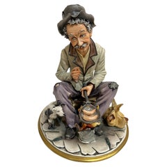 Vintage Sculpture Hand Painted"Man frying sausage on Camp Fire "