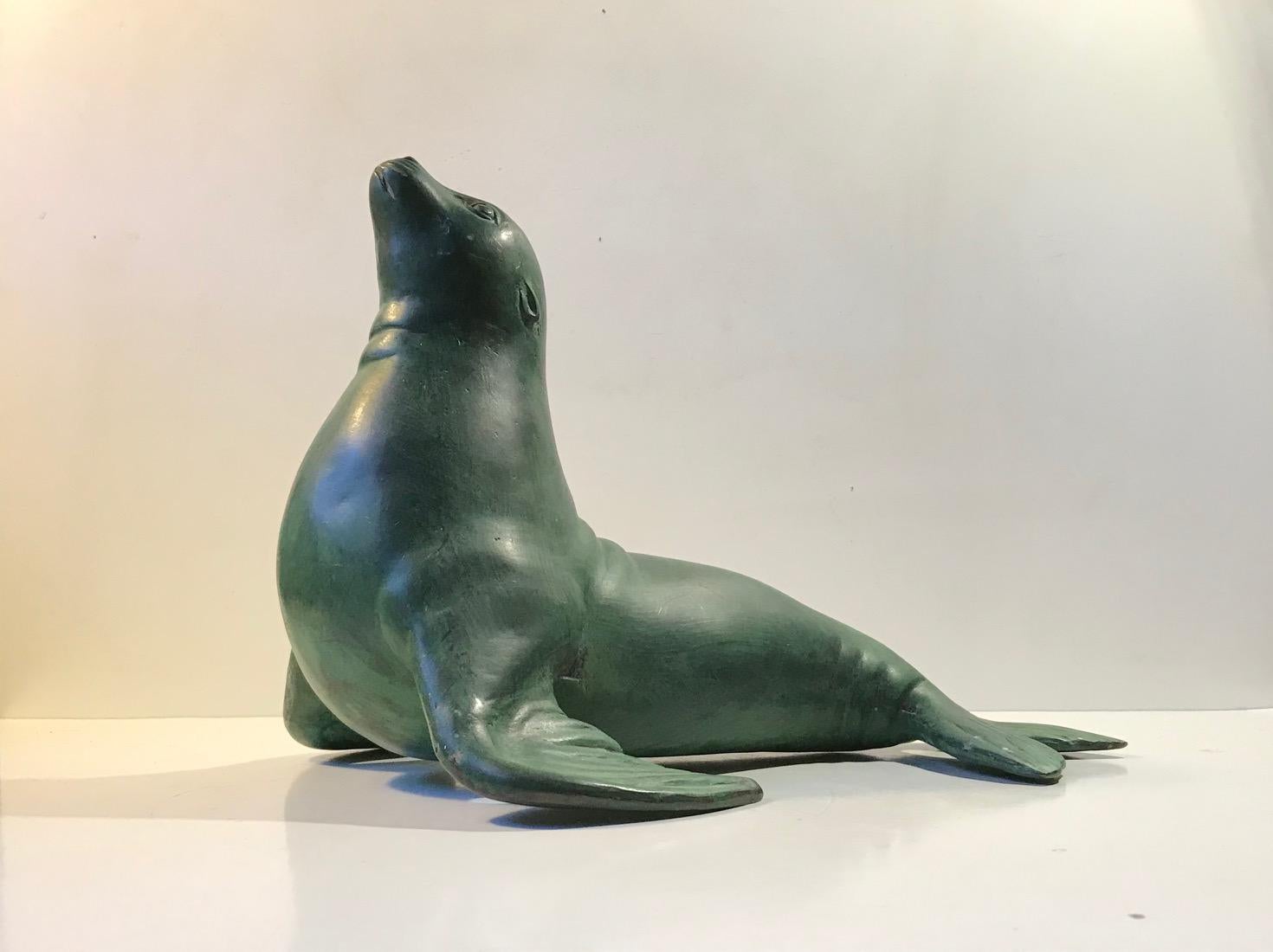 A large slightly chubby yet charming sculpture of a Seal. It is made from bronze and has an applied verdigris green surface. Anonymous Scandinavian maker circa 1970-1980. It has a hollow construction and only weights in at 2.7 kg. Use it as a